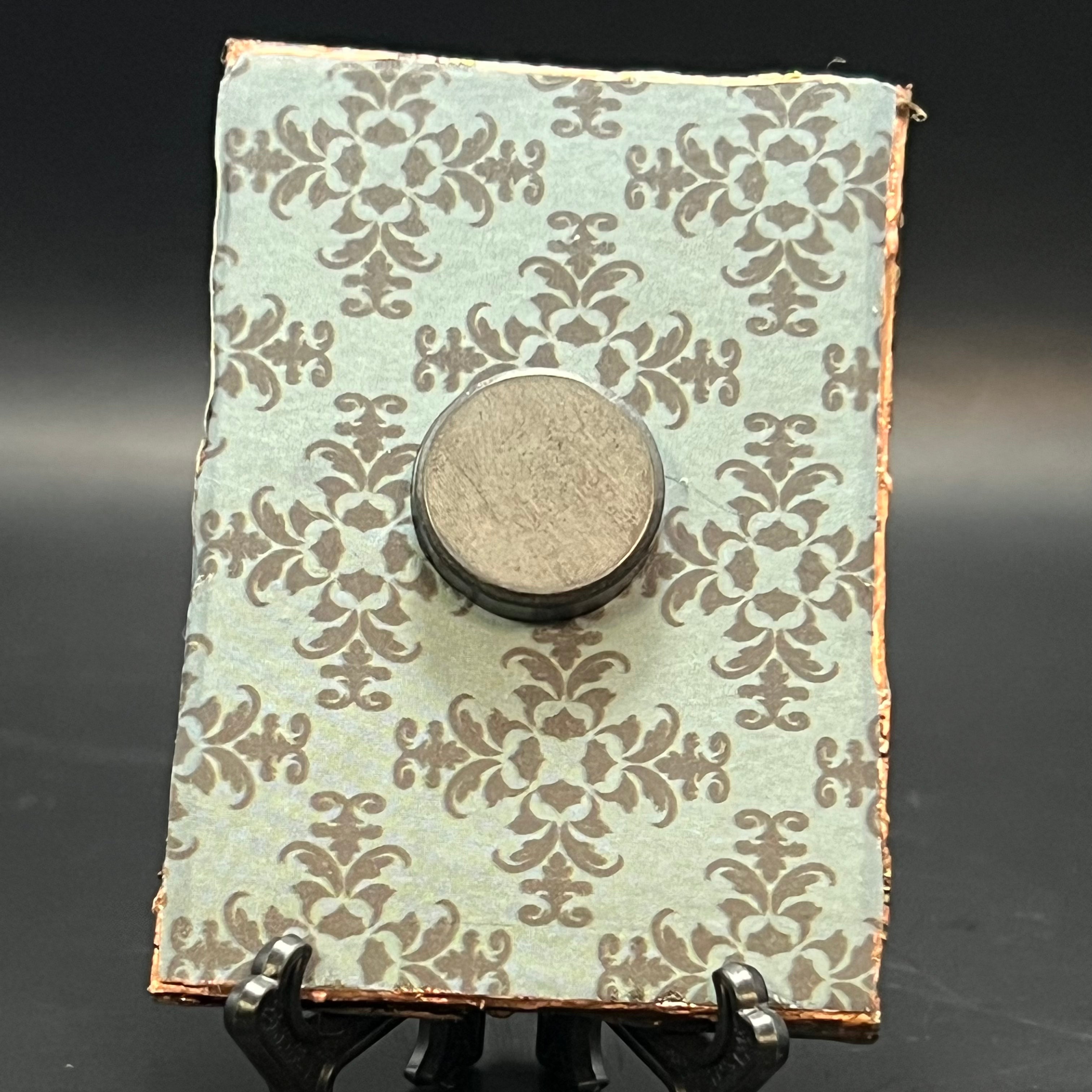 Close-up of miniature beetle details highlighting vibrant colors and textured wings on artist’s hand-painted canvas.