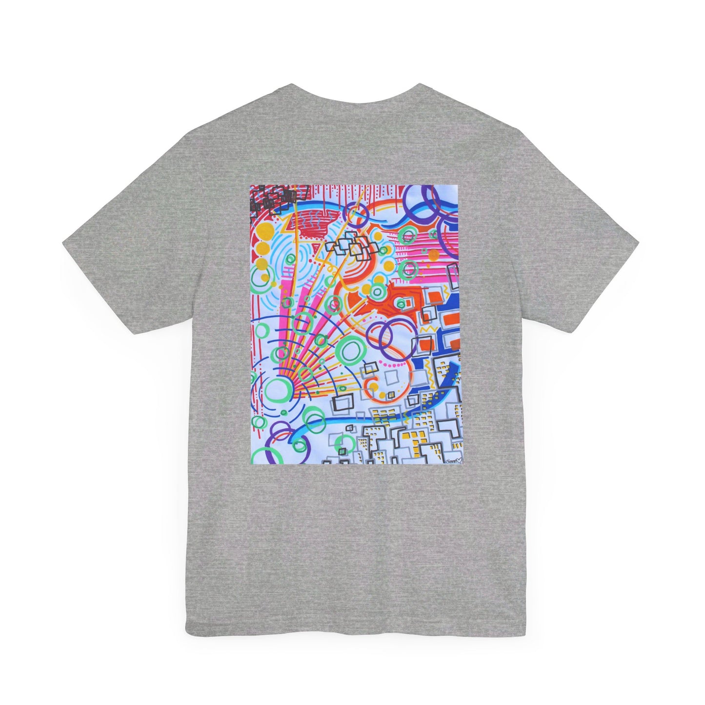 This is the Atheltic Heather The City Jersey T-Shirt by Storm Garden Studio. This showcases the back of the shirt. The image is from the upper back to the mid waist. The illustration is rectangular shaped and has a multitude of colors like blue, red, pink, yellow, green and light blue. It is an abstract image with building shapes, circles and squiggles. This is against a white background.