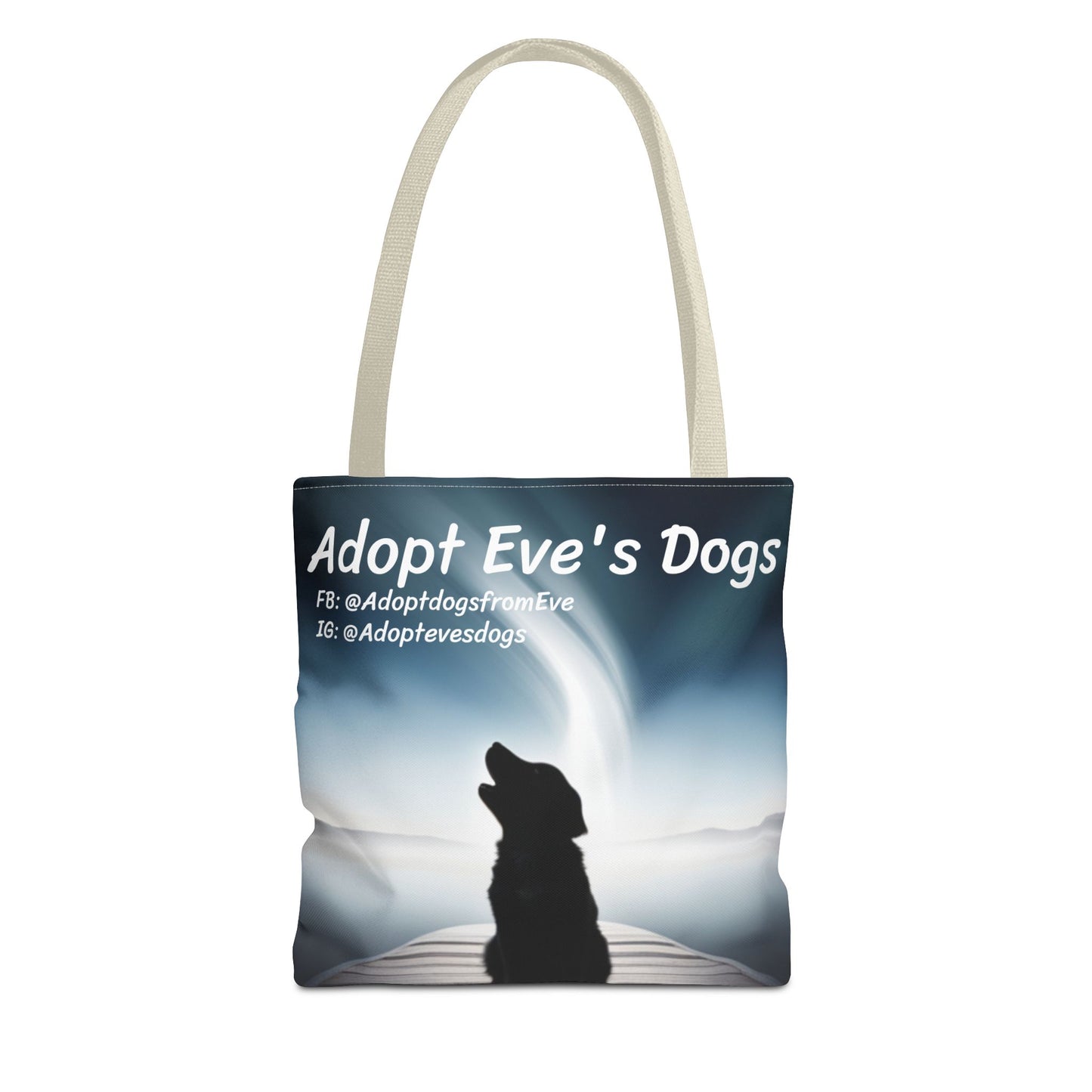 This is the Beige 13" x 13" Adopt Eve's Dogs Tote with color matched handles. This is an all around print tote with "Adopt Eve's Dogs" and socials on the top in white. The print is of a shadow of a golden retriever looking to the left on a pier towards water with mountains surrounding it. The tote is against a white background.