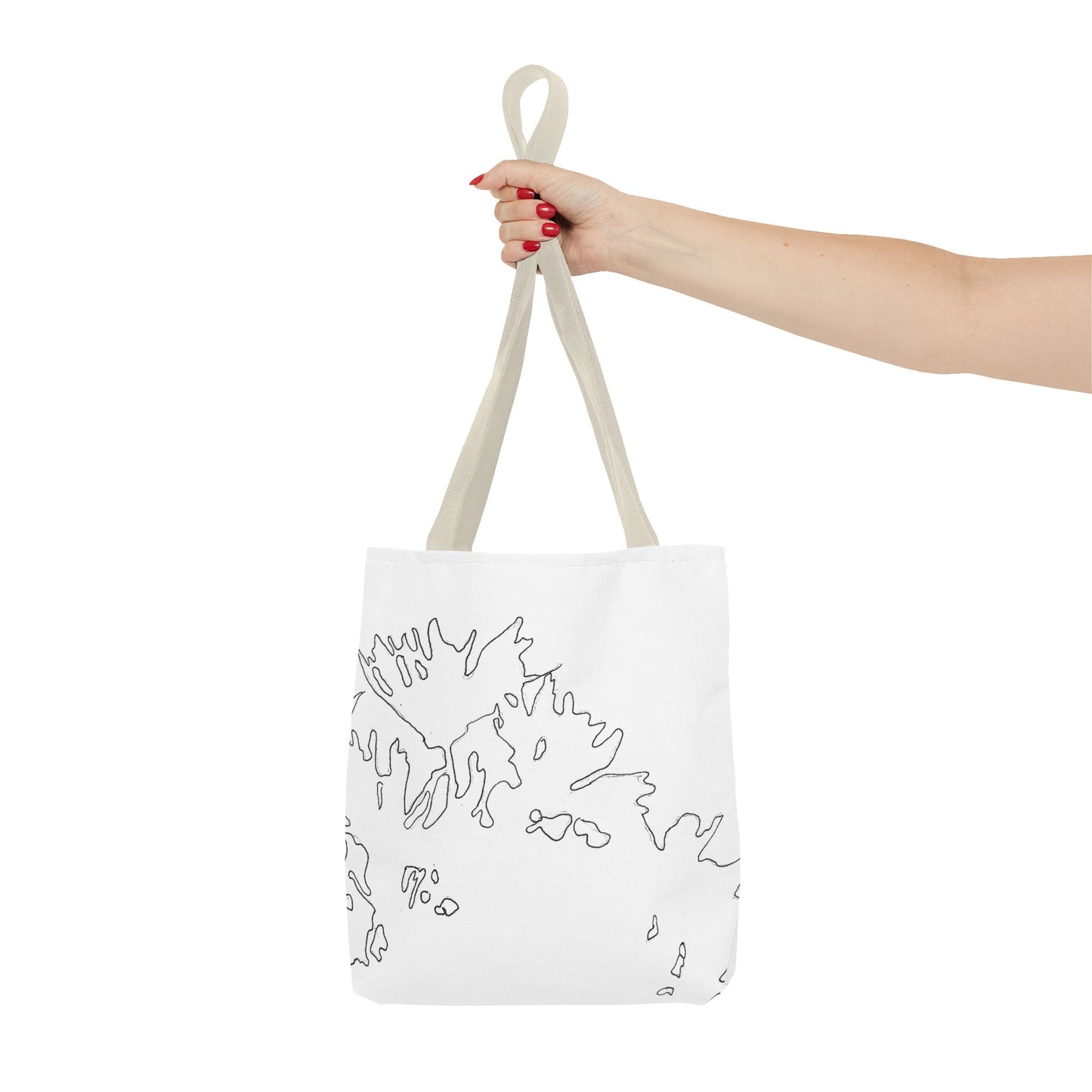This is the Beige 13" x 13" Flowers Tote Bag by Storm Garden Studio. The tote has color matched straps, abstract line work which is outlines of flowers, all over print. The colors are white and black. A lady's upper arm is to the left and a hand stretched out holding the handles of the tote in the middle. The tote is against a white background.