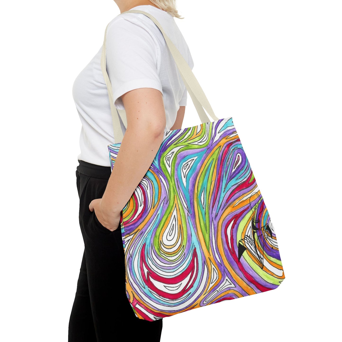 This is the Beige 18" x 18" Oil Spill Tote bag by Storm Garden Studios. A woman walking towards the left, short blonde hair, in white shirt, and black pants, one hand in the pant's pocket and carrying the bag with color matched straps that is 20" x 20", abstract colors and line work, all over print. The colors are lime green, orange, light blue, dark red, purple, white and black. Storm Garden Studio logo on bottom right of tote bag printed in black. She is against a white background.