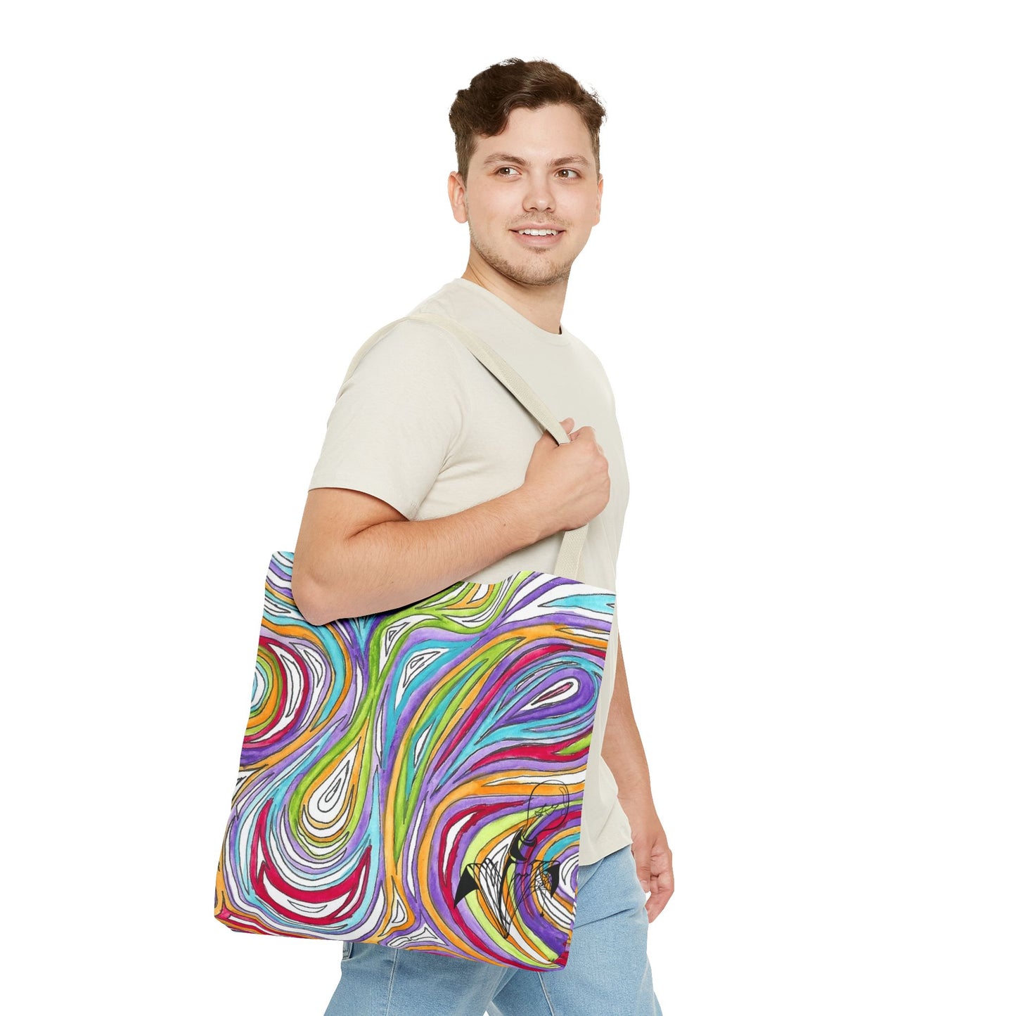 This is the Beige 18" x 18" Oil Spill Tote bag by Storm Garden Studios. Brunette man in white shirt, and blue jeans, side view walking to the right carrying the bag with color matched straps, abstract colors and line work, all over print. The colors are lime green, orange, light blue, dark red, purple, white and black. Storm Garden Studio logo printed in black on bottom right of tote bag. He is against a white background.