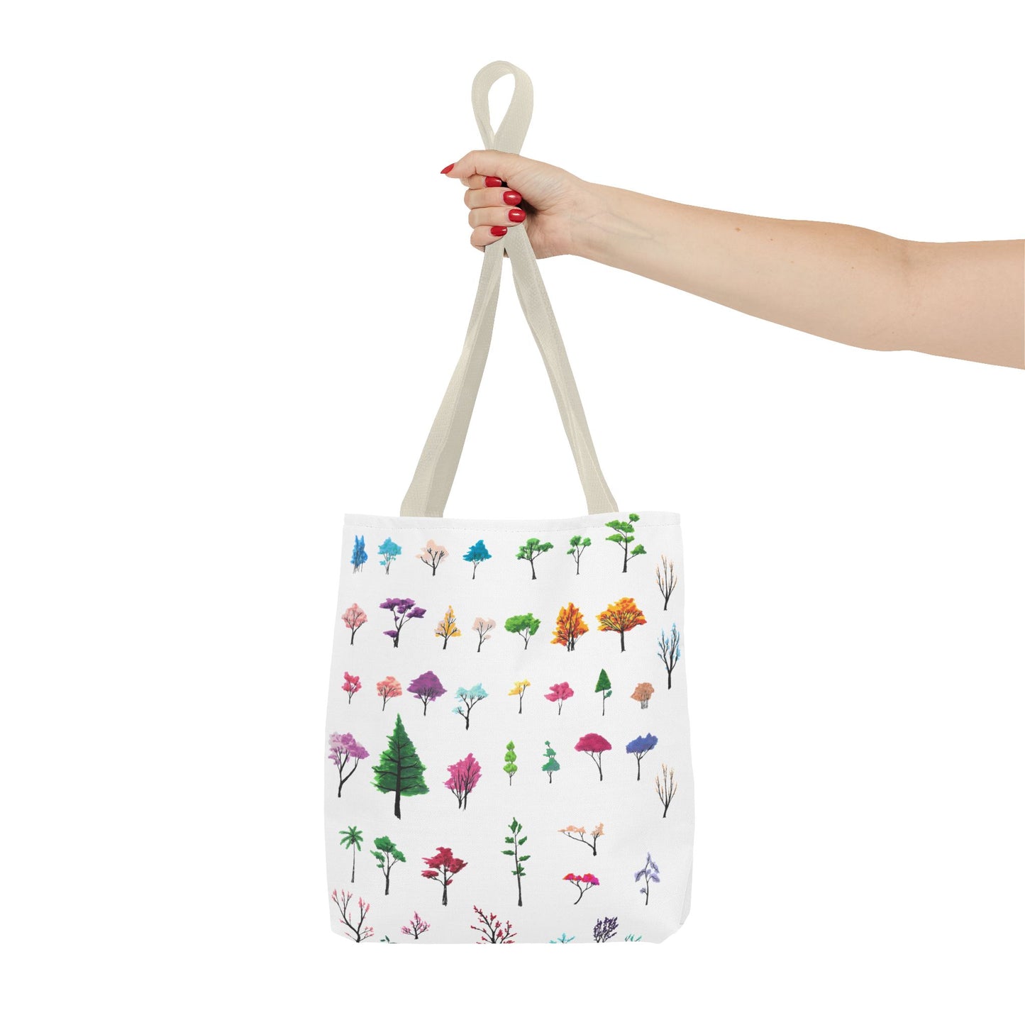 The Beige 16" x 16" Study of Trees Tote with color matched handles by Lee Hansheng Studios. There are a variety of tree illustrations from blooming fruit trees to deciduous and evergreens. The trees are colored pinks, purples, greens, yellows, blues and oranges on a white background tote. A woman's hand with red nail polish is grabbing the handles. Her arm is outstretched to the middle. The tote is against a white background.