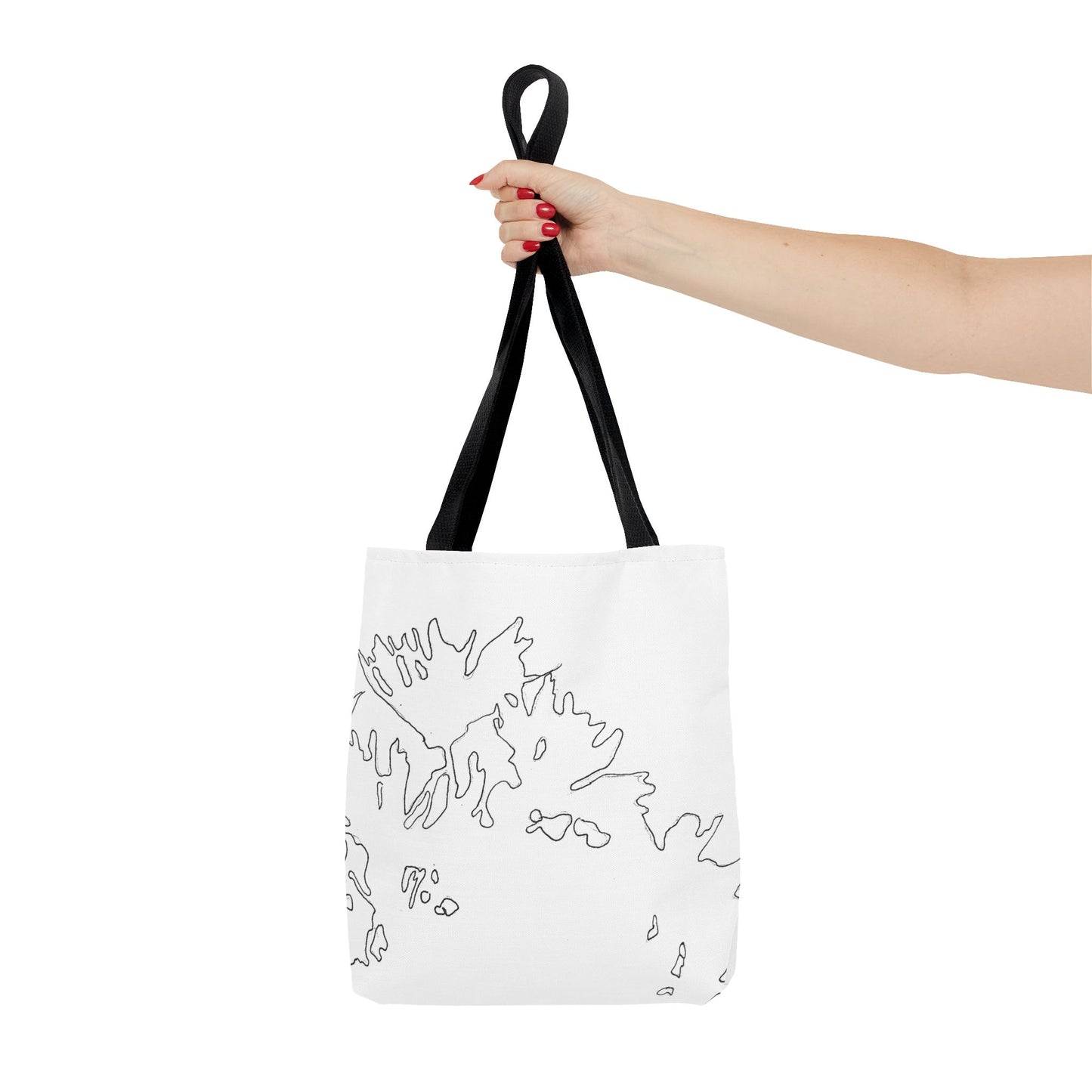 This is the Black 13" x 13" Flowers Tote Bag by Storm Garden Studio. The tote has color matched straps, abstract line work which is outlines of flowers, all over print. The colors are white and black. A lady's upper arm is to the left and a hand stretched out holding the handles of the tote in the middle. The tote is against a white background.