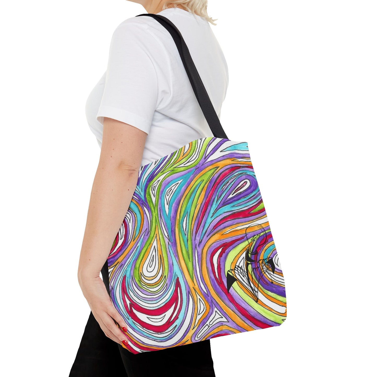 This is the Black 16" x 16" Oil Spill Tote bag by Storm Garden Studios. A woman walking towards the left, short blonde hair, in white shirt, and black pants, one hand on the tote and carrying the bag with color matched straps that is 20" x 20", abstract colors and line work, all over print. The colors are lime green, orange, light blue, dark red, purple, white and black. Storm Garden Studio logo on bottom right of tote bag printed in black. She is against a white background.