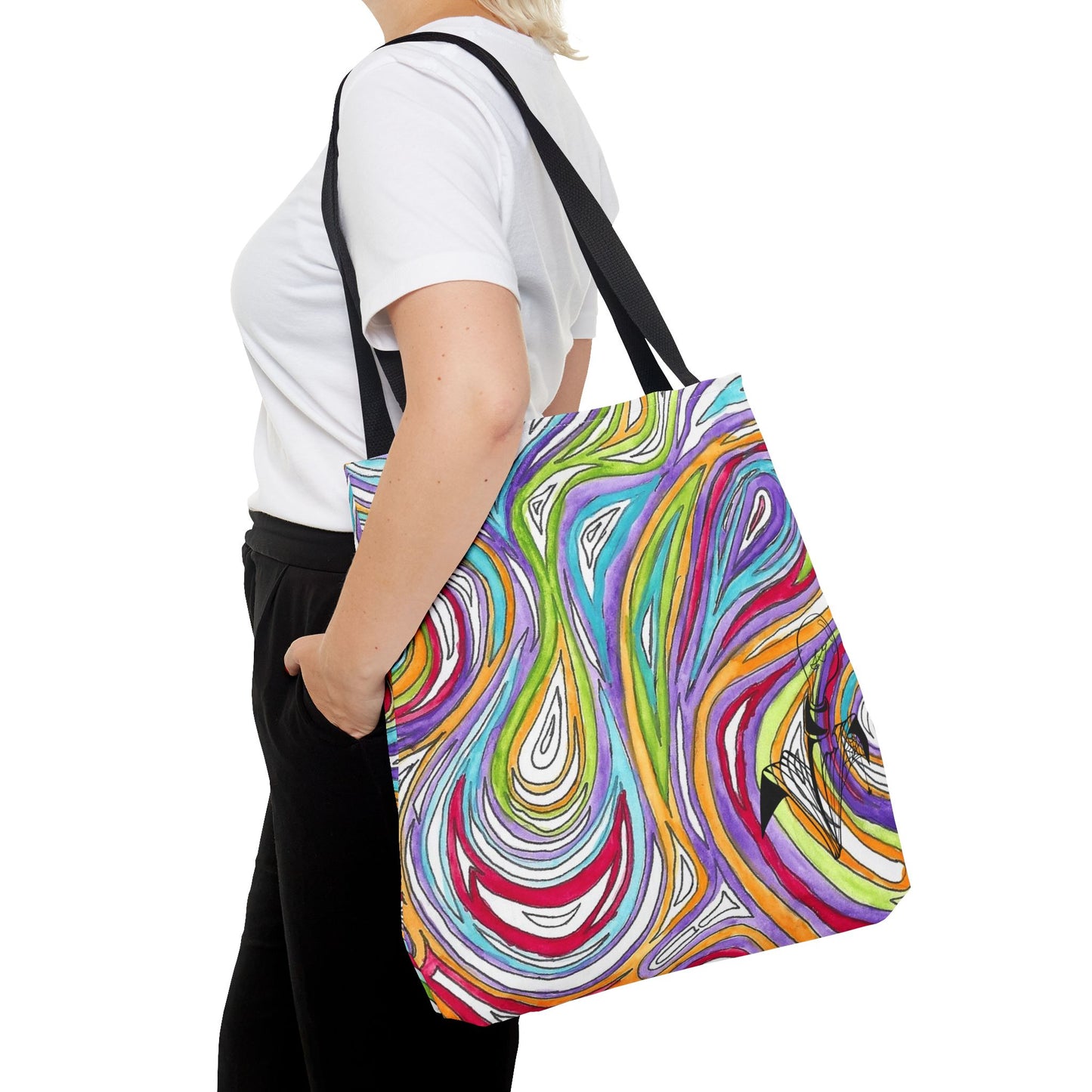 This is the Black 18" x 18" Oil Spill Tote bag by Storm Garden Studios. A woman walking towards the left, short blonde hair, in white shirt, and black pants, one hand in pant's pocket and carrying the bag with color matched straps that is 20" x 20", abstract colors and line work, all over print. The colors are lime green, orange, light blue, dark red, purple, white and black. Storm Garden Studio logo on bottom right of tote bag printed in black. She is against a white background.
