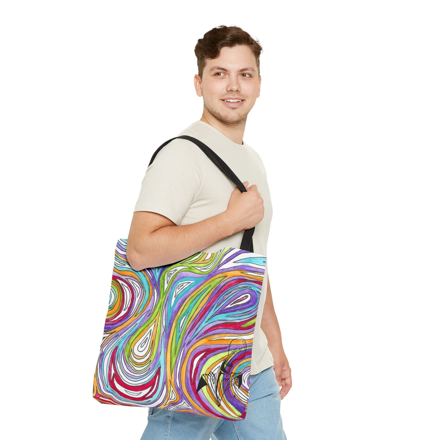 This is the Black 18" x 18" Oil Spill Tote bag by Storm Garden Studios. Brunette man in white shirt, and blue jeans, side view walking to the right carrying the bag with color matched straps, abstract colors and line work, all over print. The colors are lime green, orange, light blue, dark red, purple, white and black. Storm Garden Studio logo printed in black on bottom right of tote bag. He is against a white background.