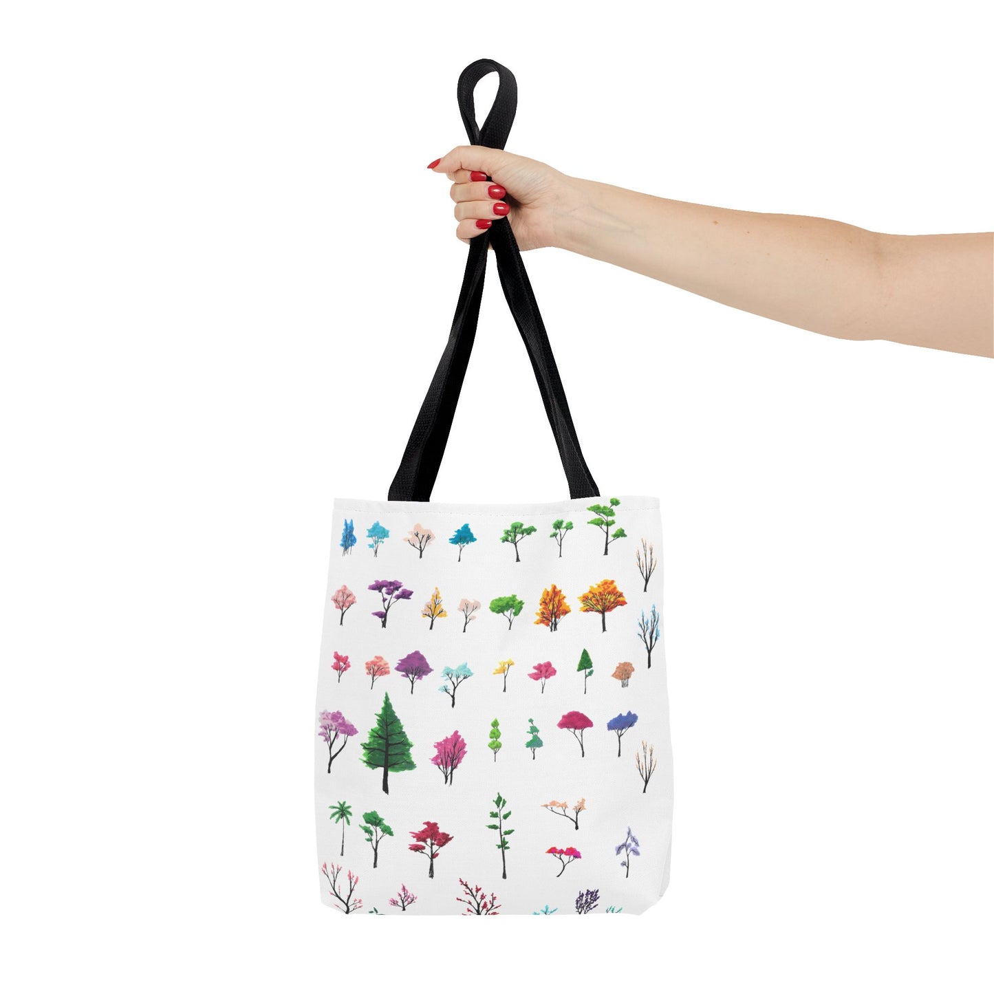 The Black 16" x 16" Study of Trees Tote with color matched handles by Lee Hansheng Studios. There are a variety of tree illustrations from blooming fruit trees to deciduous and evergreens. The trees are colored pinks, purples, greens, yellows, blues and oranges on a white background tote. A woman's hand with red nail polish is grabbing the handles. Her arm is outstretched to the middle. The tote is against a white background.