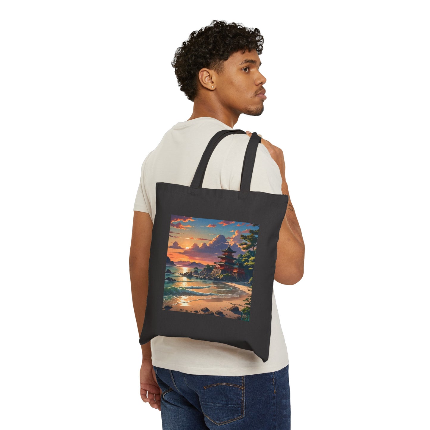 This is the Black 15" x 16" Temple of Peace Canvas Tote Bag by Lee Hansheng Studios.The illustration shows a setting red/orange sun above clouds,two blue roof,brown/red walled temples on the right on top of the hills,mountains,blue/white waves into sand and a forest to the right.On the bottom right corner is the logo printed in black for the studio and outlined in blue. A man is hanging the tote over his shoulder looking to the right with a white tee and dark jeans against a white background.