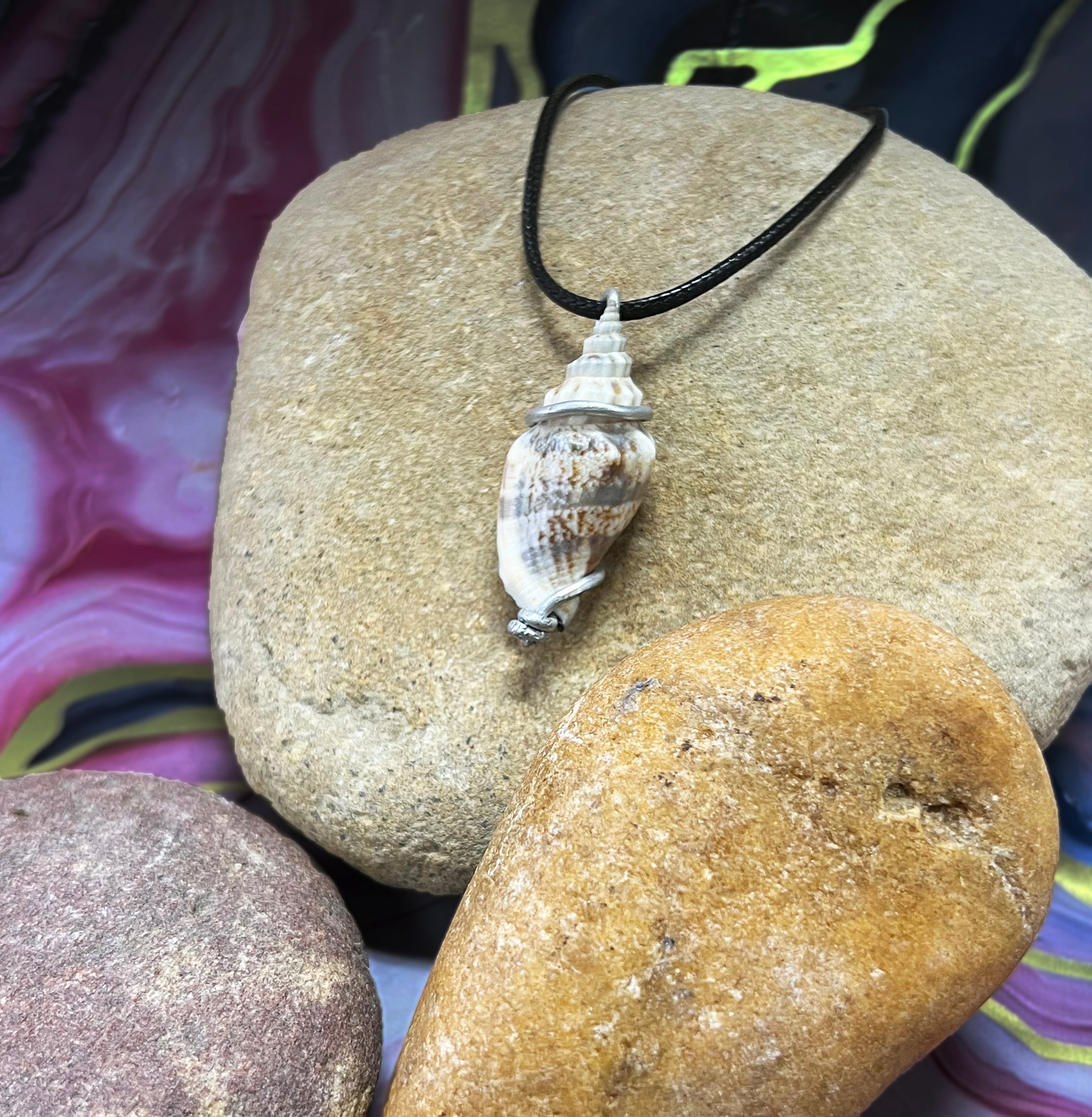 SGS Conidae wire wrap necklace featuring blue, white, and warm brown speckled enamel, sterling silver chain, and lobster