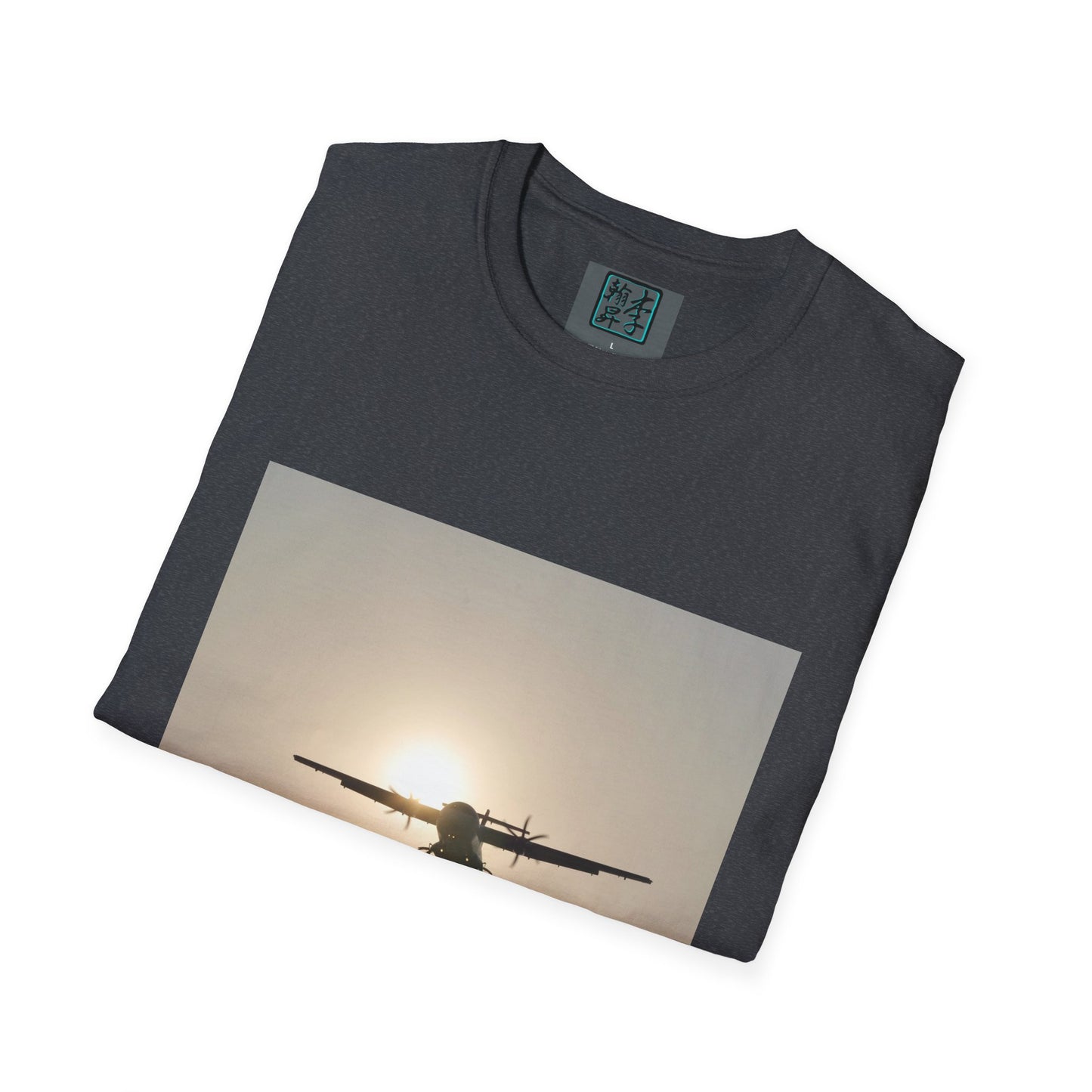This is the Dark Heather Grey Landing T-Shirt by Lee Hansheng Studios. This is an image of the front folded. On the inside of the shirt is the logo for the studio printed in black outlined in blue, gray size label with the print being white. The illustration is a rectangular design of an airplane landing. There is an orange/yellow sun with the shadowed plane. The shirt is against a white background.