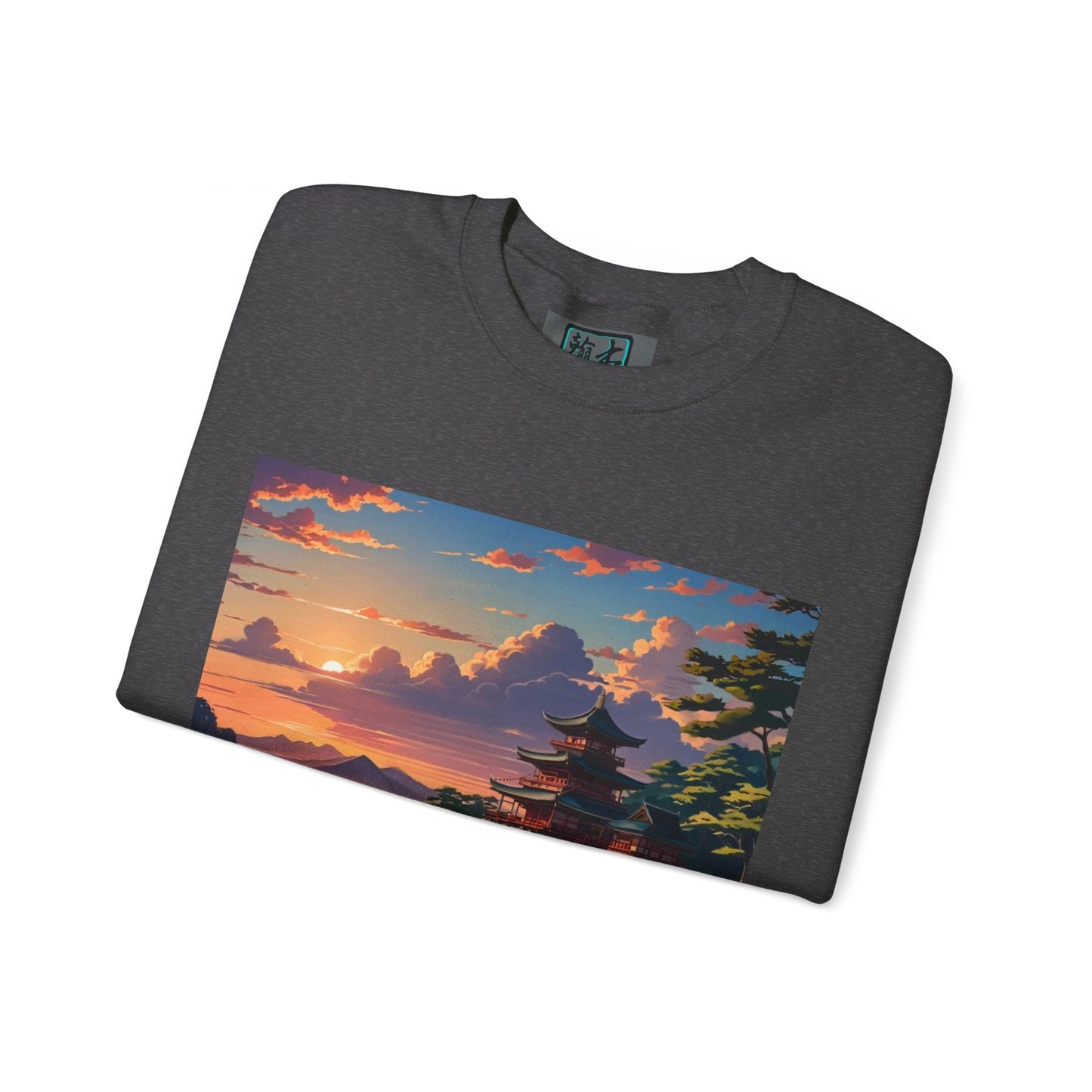 This is the Dark Heather Temple of Peace Sweatshirt by Lee Hansheng Studios. It comes in sizes S-5XL. This is an image of the sweatshirt from the front and folded. On the inside of the shirt there is a little of the studio's logo showing and the illustration shows the top of the landscape. There is a setting red/orange sun above clouds, one blue roof,brown/red walled temples on the right thre are some trees and mountains in the background scenery. The shirt is against a white background.