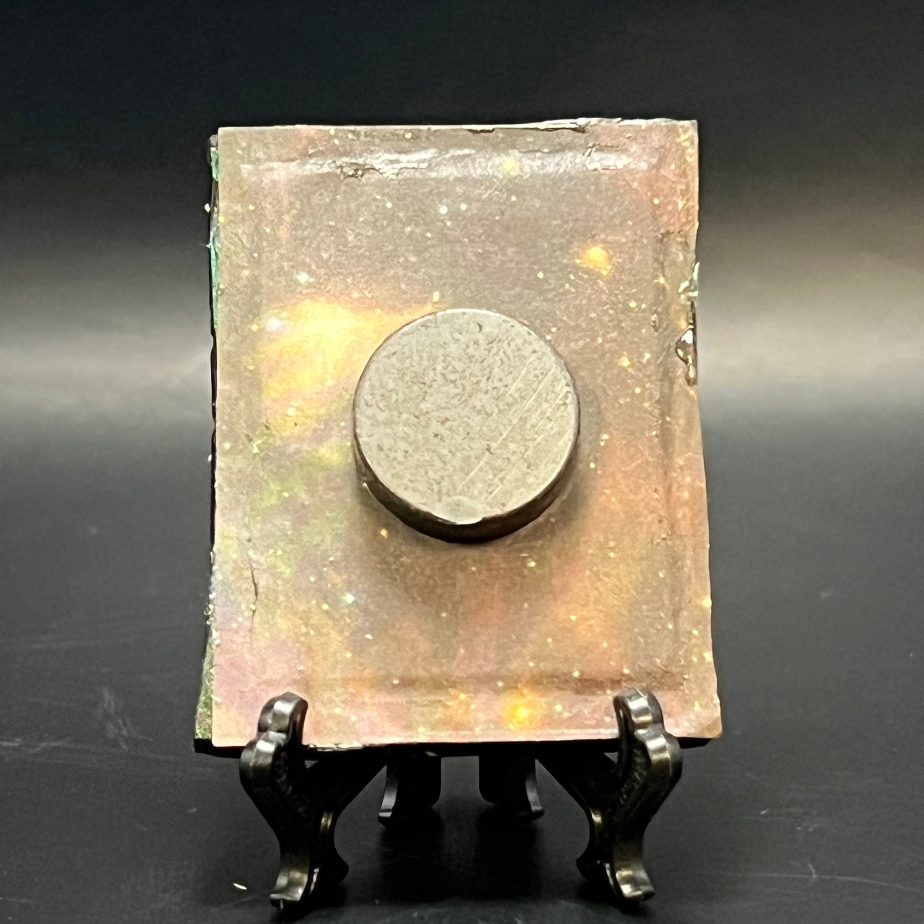 Close-up of the CFD Distant Ringed Planet miniature with detailed metallic silver finish and tiny gemstone accents on the