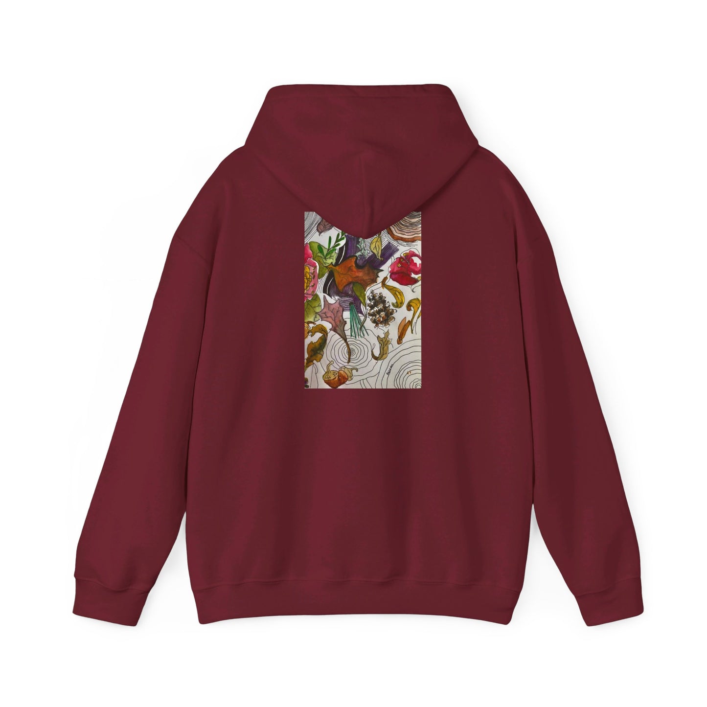 This is the Garnet Fall is falling Heavy Blend Hooded Sweatshirt by Storm Garden Studio. It comes in sizes S-5XL. The image is from the back with the hood down. The drawstring is color matched. The illustration is within a rectangle starting from the upper back to mid back. There are various conifers like leaves,pine cones,etc. There are also some flowers and a tree trunk ring.The colors are red, yellow, dark brown, purples, and green. It is against from a white background.