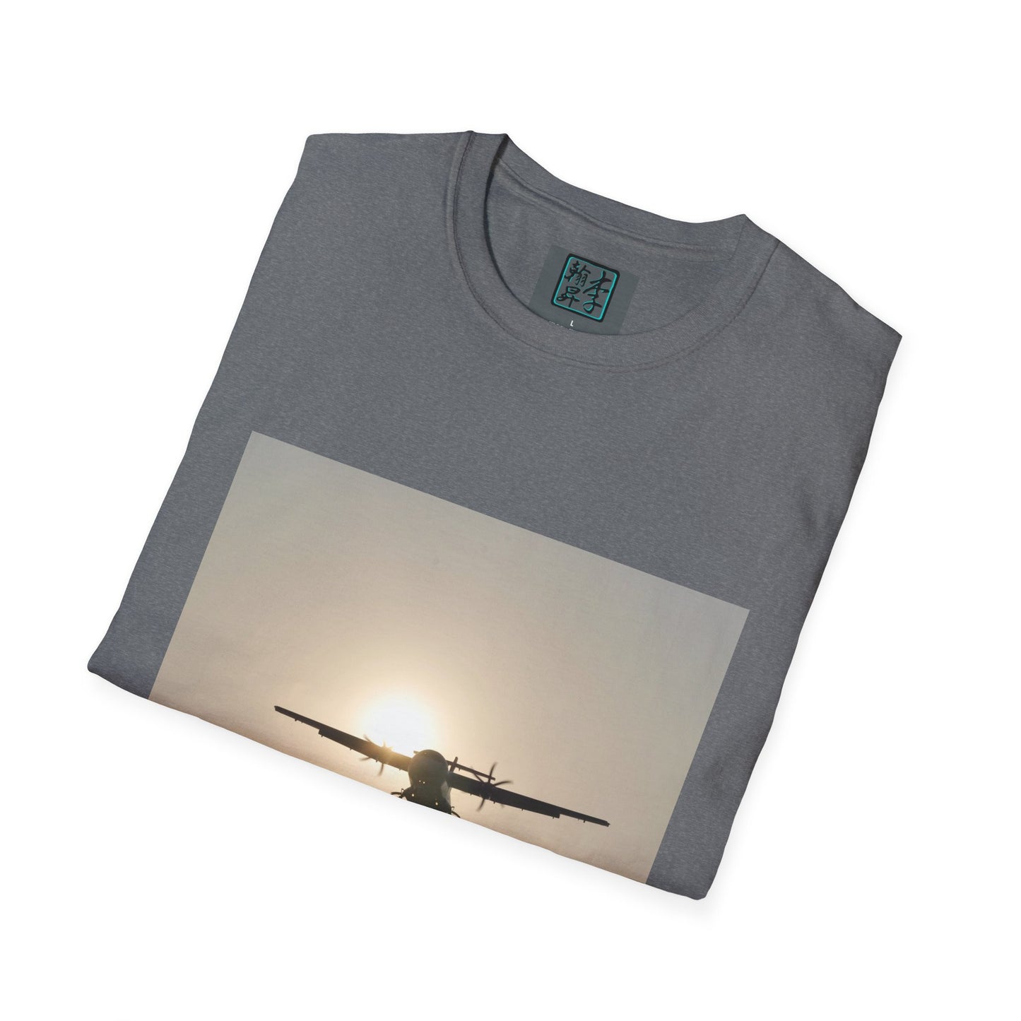 This is the Graphite Heather Landing T-Shirt by Lee Hansheng Studios. This is an image of the front folded. On the inside of the shirt is the logo for the studio printed in black outlined in blue, gray size label with the print being white. The illustration is a rectangular design of an airplane landing. There is an orange/yellow sun with the shadowed plane. The shirt is against a white background.