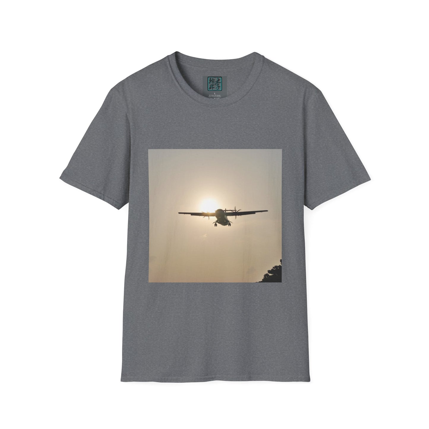 This is the Graphite Heather Landing T-Shirt by Lee Hansheng Studios. This is an image of the front folded. On the inside of the shirt is the logo for the studio printed in black outlined in blue, gray size label with the print being white. The illustration is a rectangular design of an airplane landing. There is an orange/yellow sun with the shadowed plane. Some trees on the right end corner. The shirt is against a white background.