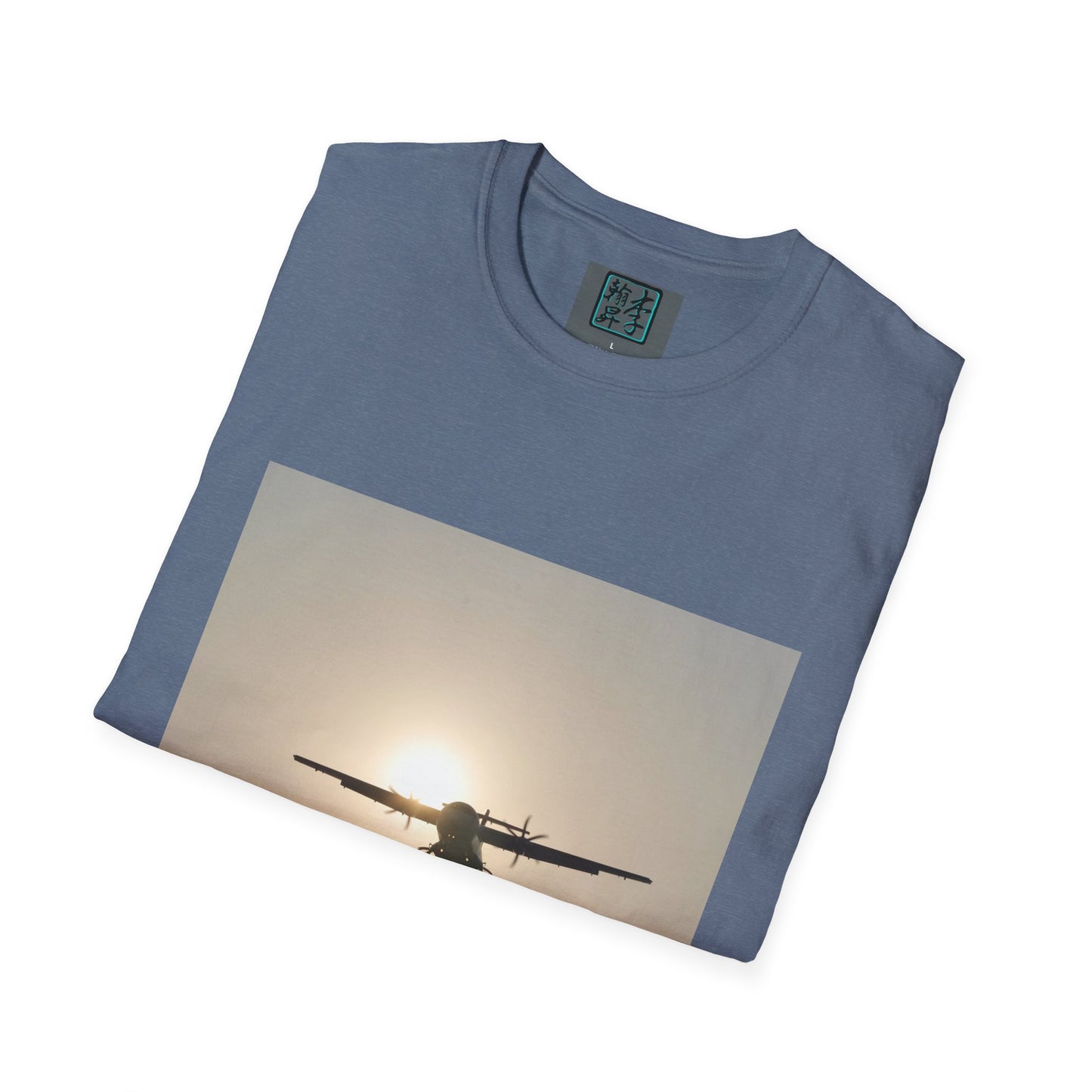This is the Heather Indigo Landing T-Shirt by Lee Hansheng Studios. This is an image of the front folded. On the inside of the shirt is the logo for the studio printed in black outlined in blue, gray size label with the print being white. The illustration is a rectangular design of an airplane landing. There is an orange/yellow sun with the shadowed plane. The shirt is against a white background.