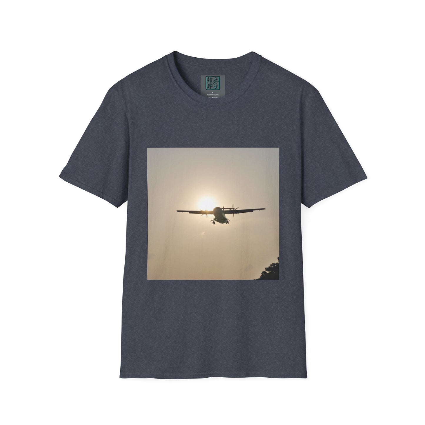This is the Dark Heather Landing T-Shirt by Lee Hansheng Studios. This is an image of the front folded. On the inside of the shirt is the logo for the studio printed in black outlined in blue, gray size label with the print being white. The illustration is a rectangular design of an airplane landing. There is an orange/yellow sun with the shadowed plane. Some trees on the right end corner. The shirt is against a white background.
