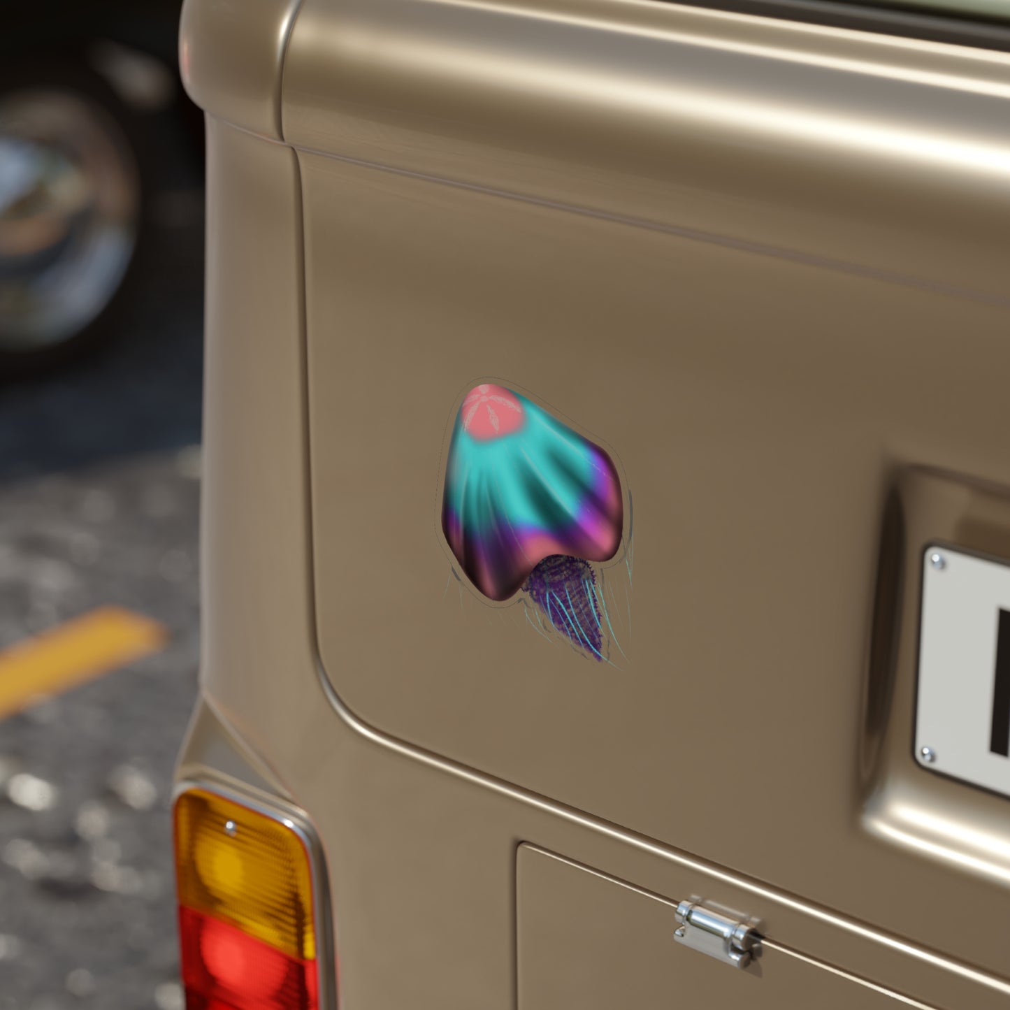 A 5" x 5" die cut transparent sticker of a pink, blue and purple jellyfish on a car.