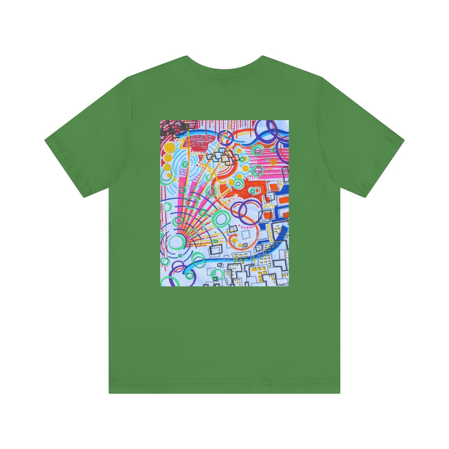 This is the Leaf The City Jersey T-Shirt by Storm Garden Studio. This showcases the back of the shirt. The image is from the upper back to the mid waist. The illustration is rectangular shaped and has a multitude of colors like blue, red, pink, yellow, green and light blue. It is an abstract image with building shapes, circles and squiggles. This is against a white background.