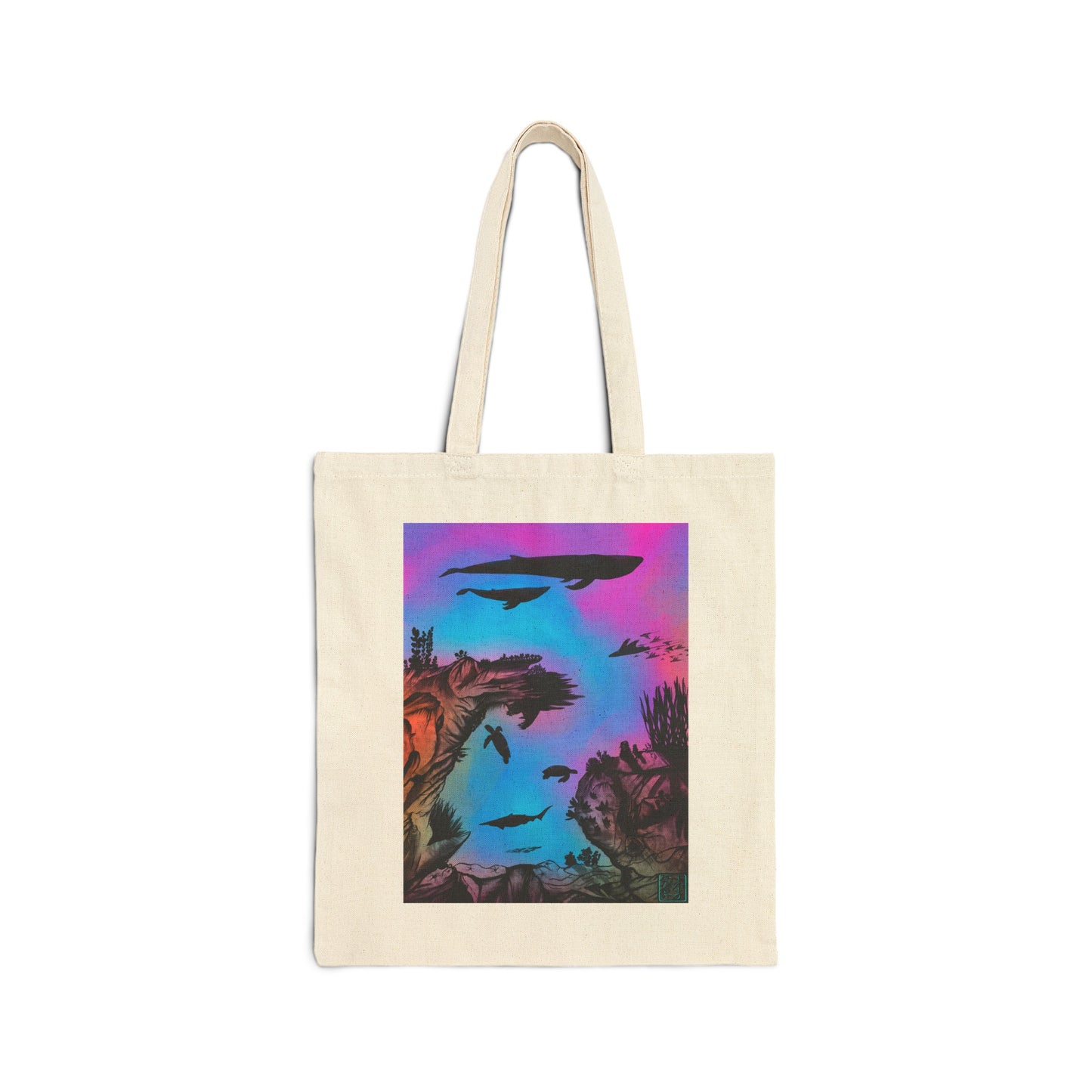 This is the Natural 15" x 16" Into the Abyss Canvas Tote by Lee Hansheng Studios. The illustration is underwater seascape with aquatic plants on a marbled background. There are two blue whales, 1 goblin shark, school of eagle rays, two sea turtles and a school of fish. On the bottom right corner is the studio logo printed in black outlined in blue. The colors are pink, purple, blue and red/orange. It is against a white background.