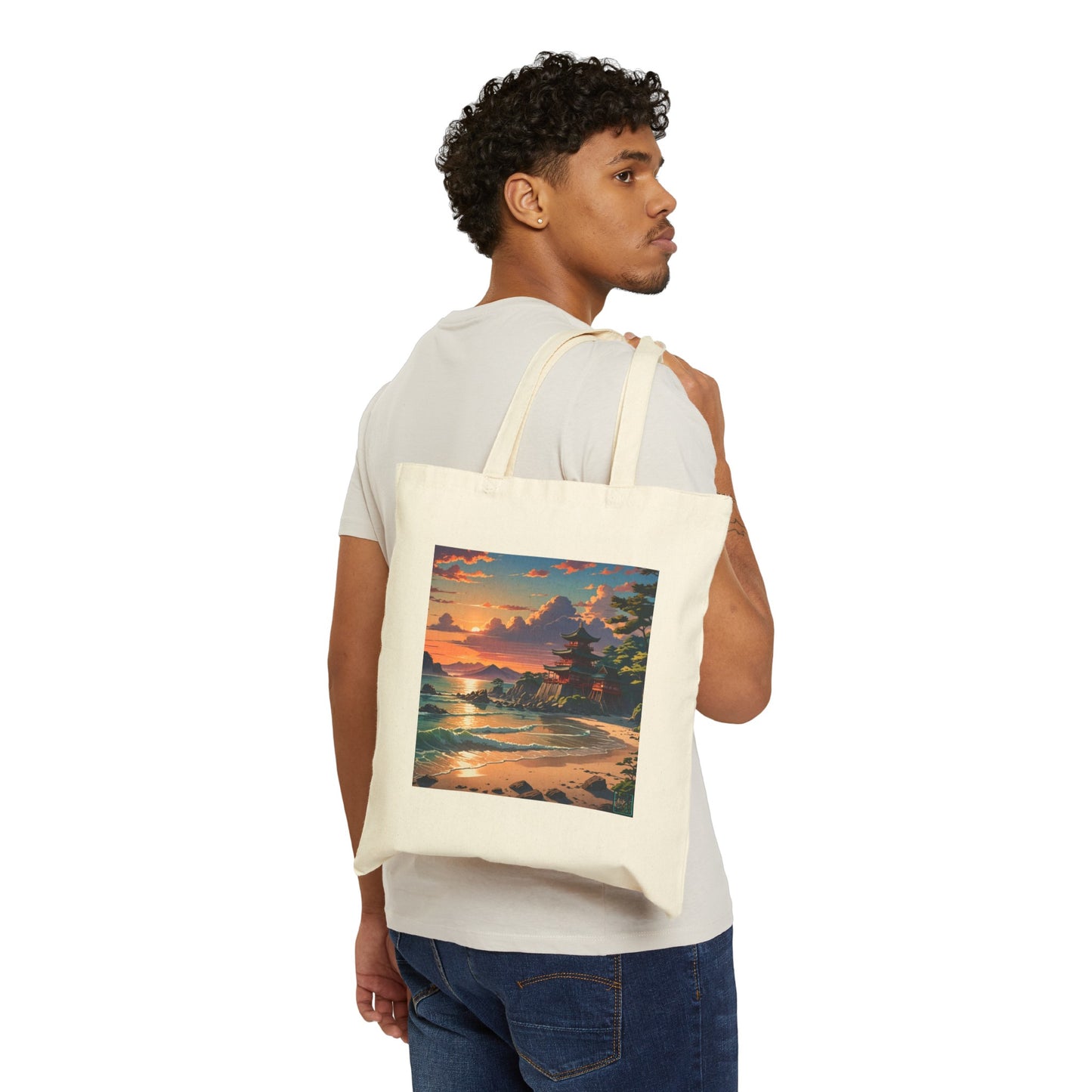 This is the Natural 15" x 16" Temple of Peace Canvas Tote Bag by Lee Hansheng Studios.The illustration shows a setting red/orange sun above clouds,two blue roof,brown/red walled temples on the right on top of the hills,mountains,blue/white waves into sand and a forest to the right.On the bottom right corner is the logo printed in black for the studio and outlined in blue. A man is hanging the tote over his shoulder looking to the right with a white tee and dark jeans against a white background.