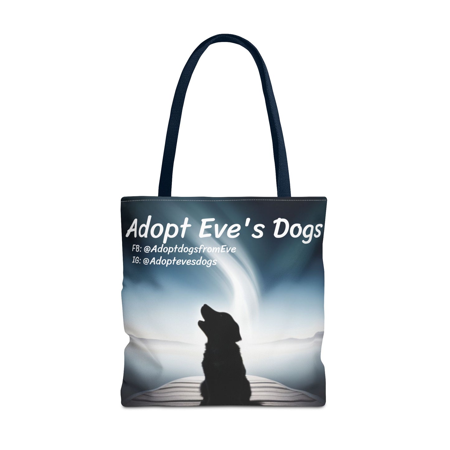 This is the Navy 18" x 18" Adopt Eve's Dogs Tote with color matched handles. This is an all around print tote with "Adopt Eve's Dogs" and socials on the top in white. The print is of a shadow of a golden retriever looking to the left on a pier towards water with mountains surrounding it. The tote is against a white background.