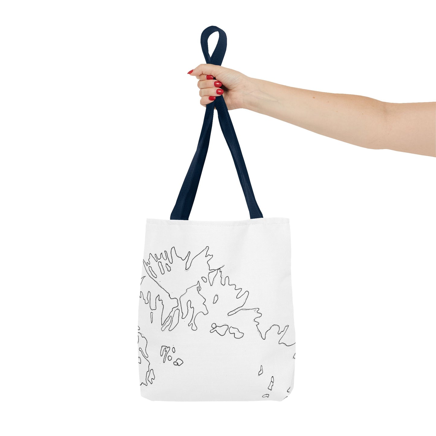 This is the Navy 13" x 13" Flowers Tote Bag by Storm Garden Studio. The tote has color matched straps, abstract line work which is outlines of flowers, all over print. The colors are white and black. A lady's upper arm is to the left and a hand stretched out holding the handles of the tote in the middle. The tote is against a white background.