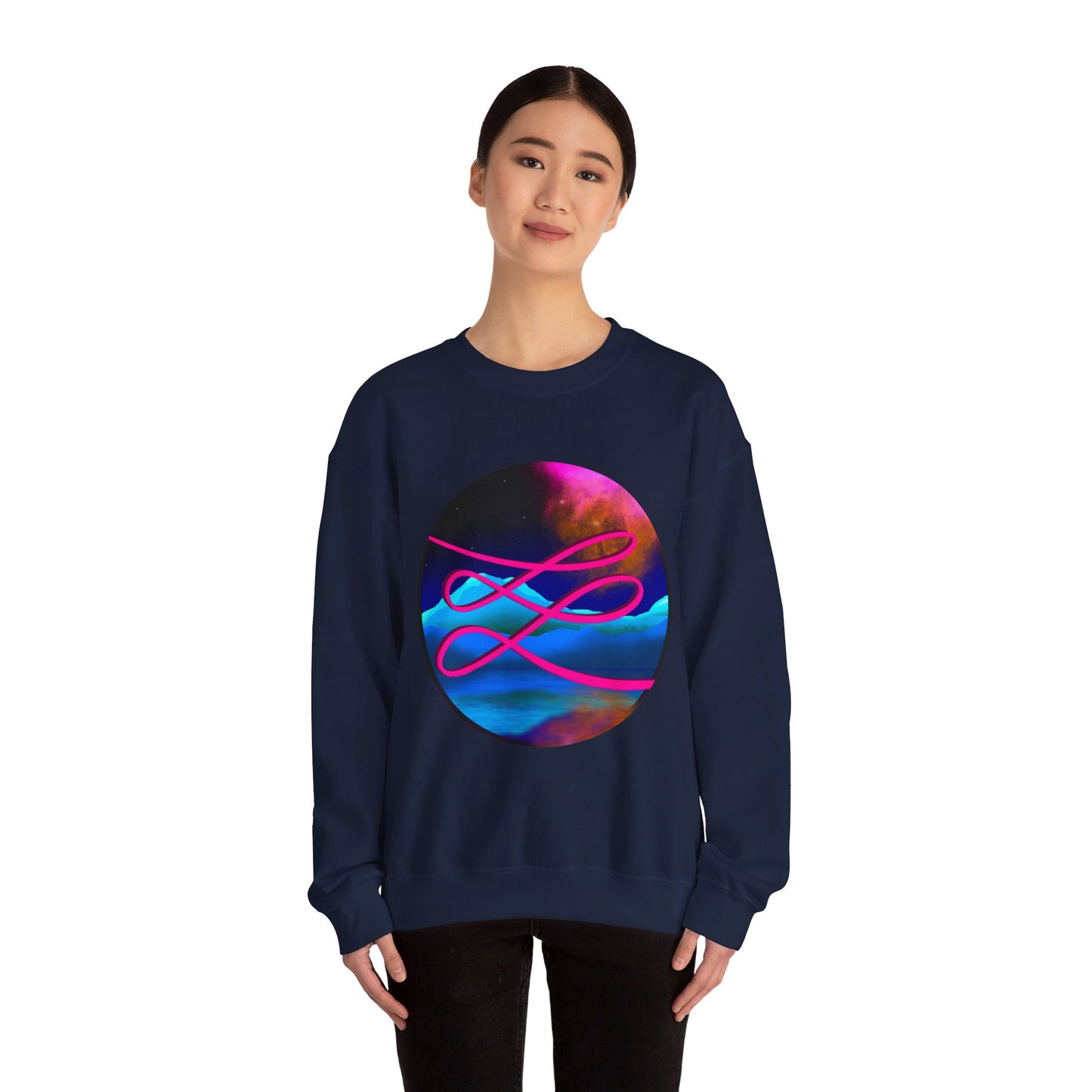 This is the Navy Swirl Heavy Blend Crewneck Sweatshirt by Lee Hansheng Studios. It comes in sizes S-3XL. The illustration is circular and covers the front of the shirt. The design is a hot pink swirl from left to right. The background has a mountain landscape that is reflected. The colors are pink, black, orange and blue. A lady with a smile, black hair tied up and black jeans is standing wearing the sweatshirt with her hands to the sides. She is against a white background.