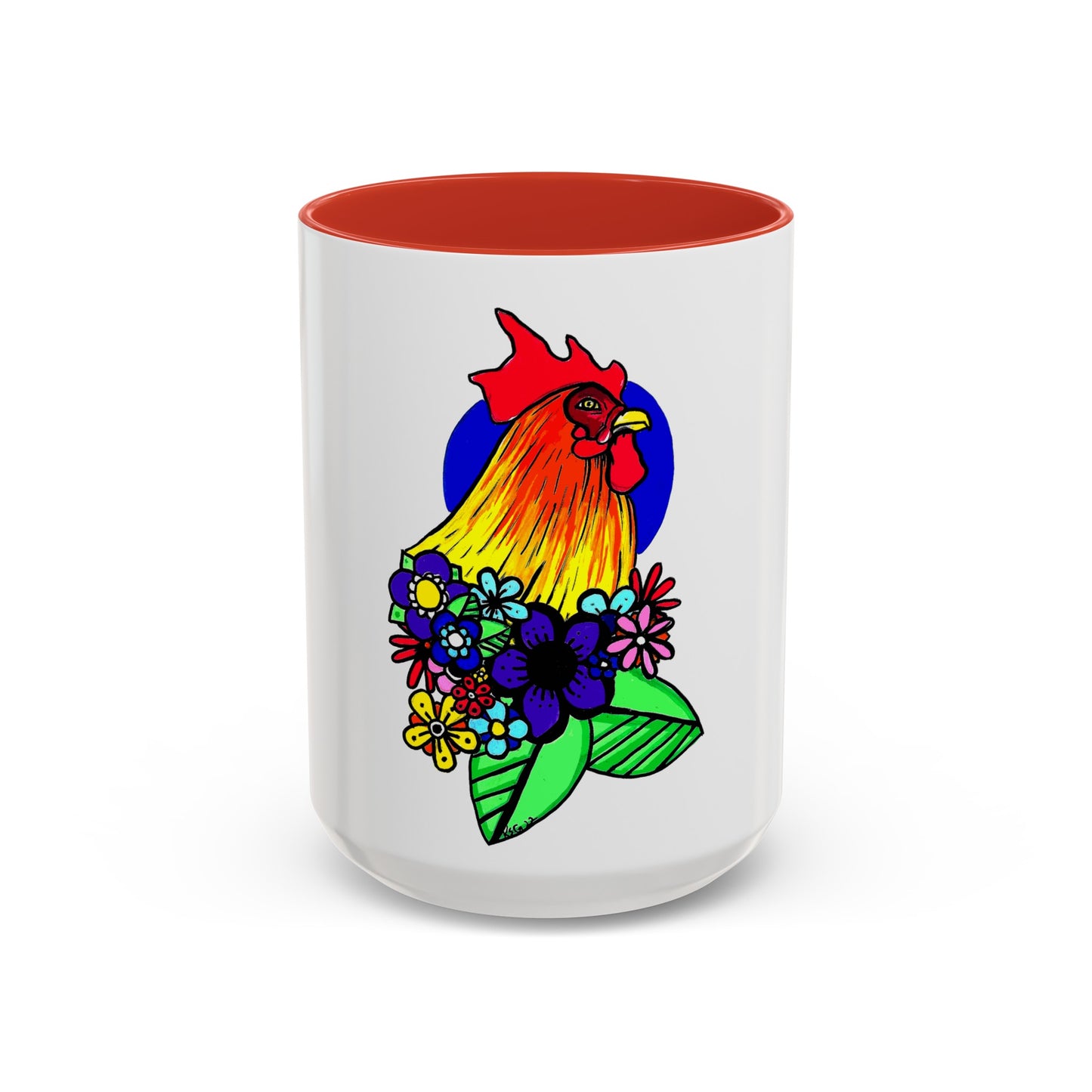 This it the Red 15 oz Cock Accent Coffee Mug by Storm Garden Studio. This image showcases the front of the mug. The illustration is of a rooster with a dark blue circular background. The rooster is adorned with flowers on the bottom of its neck. It is bright green, dark blue, yellow, orange and pink. The rooster is bright red and fades into yellow. The mug is against a white background.