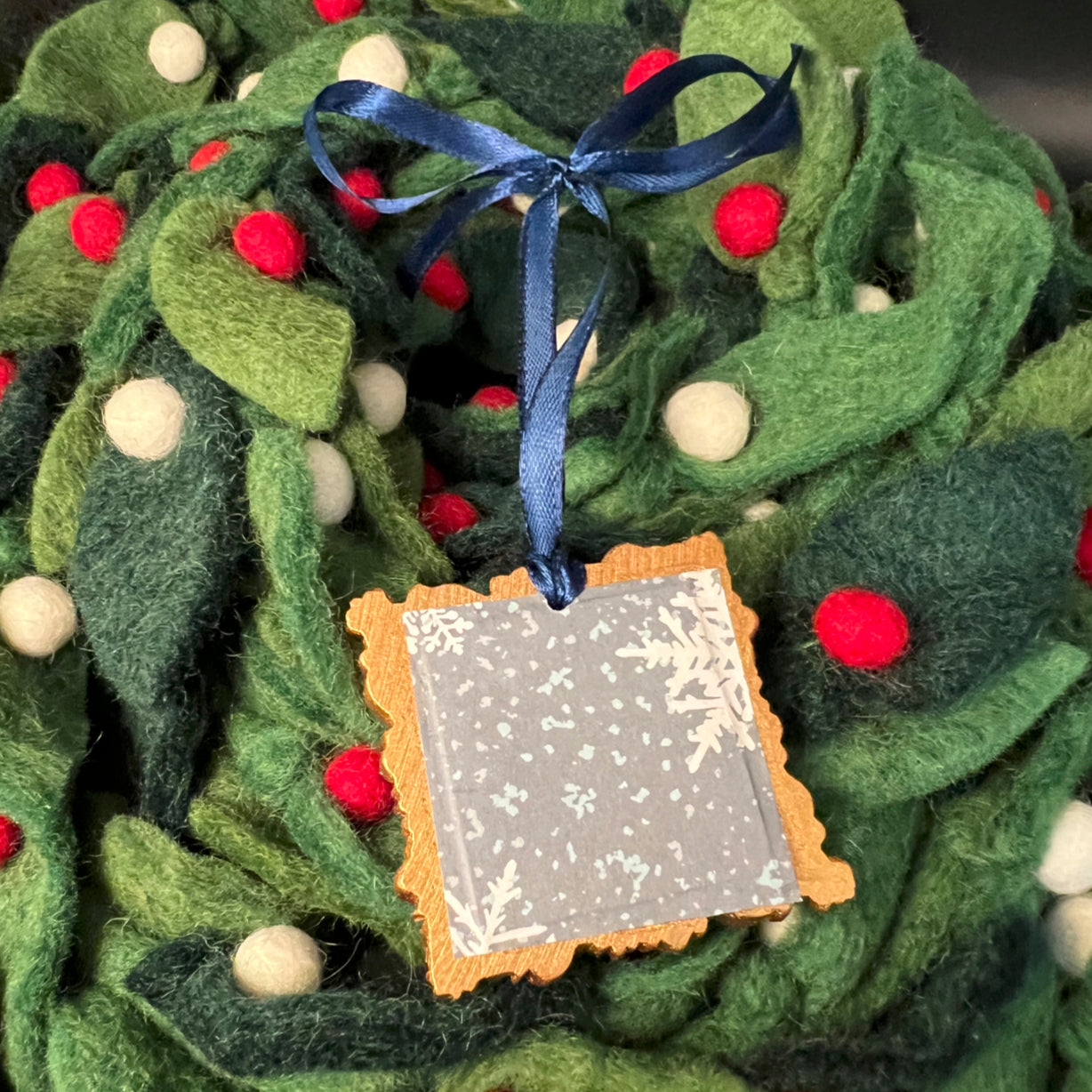 Close-up of the snowflake arrow ornament’s textured frosted surface and intricate arrow detailing on the front side.