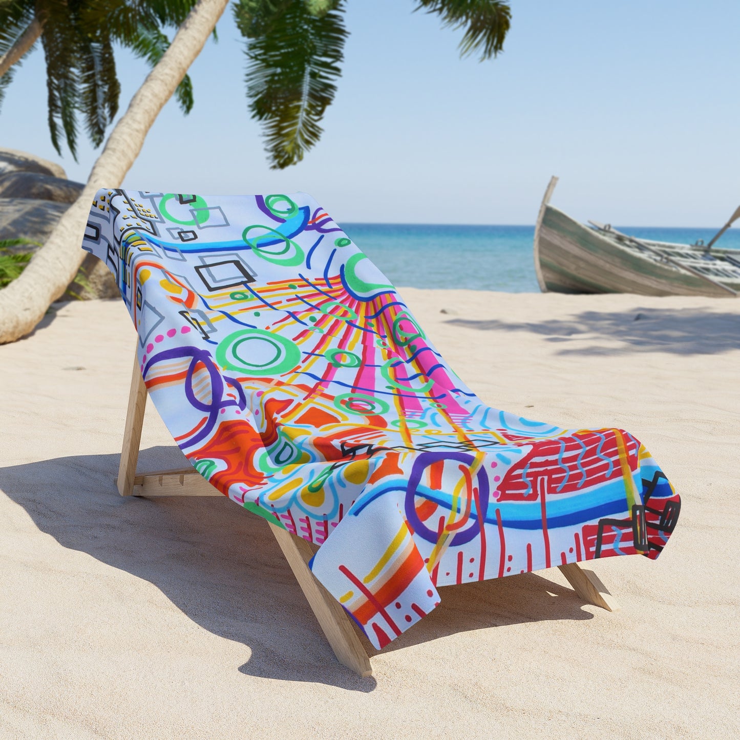 This is the 36" x 72" The City Beach Towel by Storm Garden Studio. The illustration is rectangular shaped and has a multitude of colors like blue, red, pink, yellow, green and light blue. It is an abstract image with building shapes, circles and squiggles. The towel is on a light wood beach chair with a beach background including sand, palm tree on the left and a boat to the right.