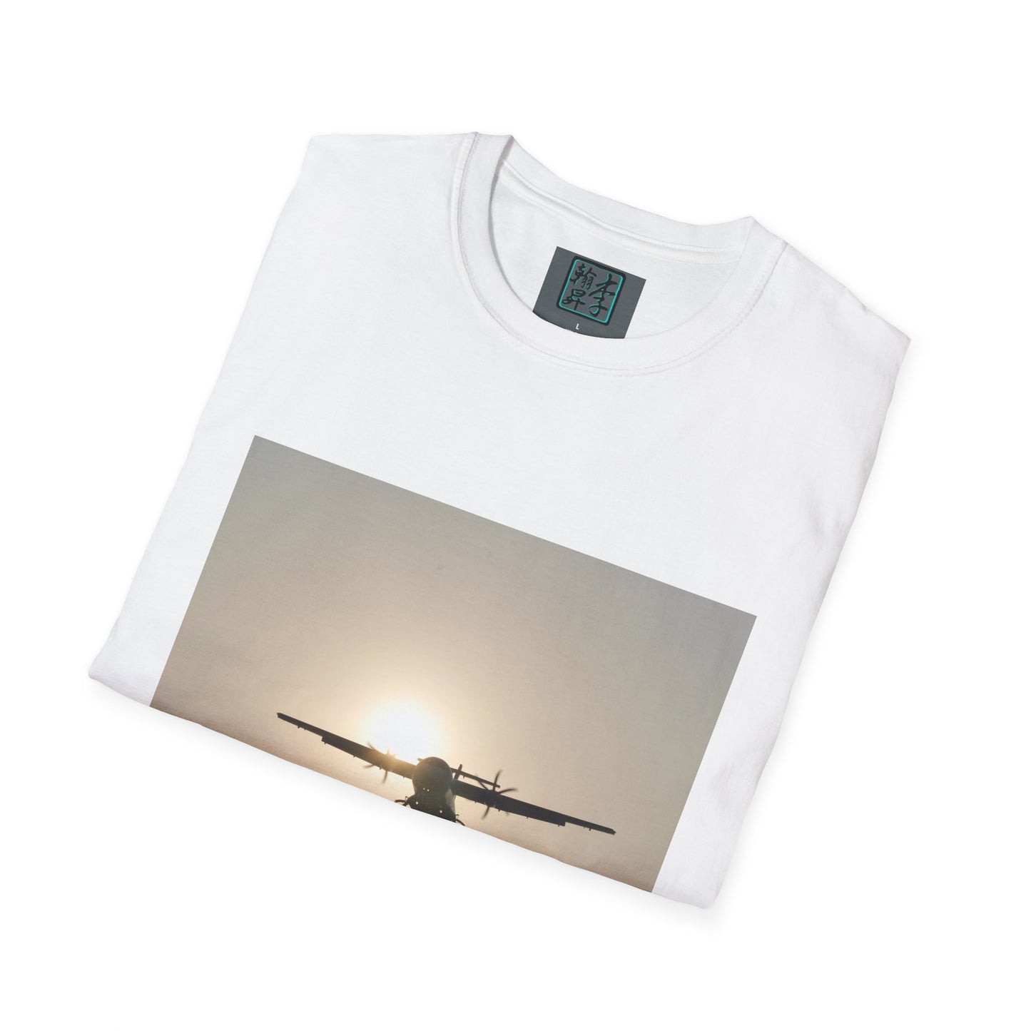 This is the White Landing T-Shirt by Lee Hansheng Studios. This is an image of the front folded. On the inside of the shirt is the logo for the studio printed in black outlined in blue, gray size label with the print being white. The illustration is a rectangular design of an airplane landing. There is an orange/yellow sun with the shadowed plane. The shirt is against a white background.