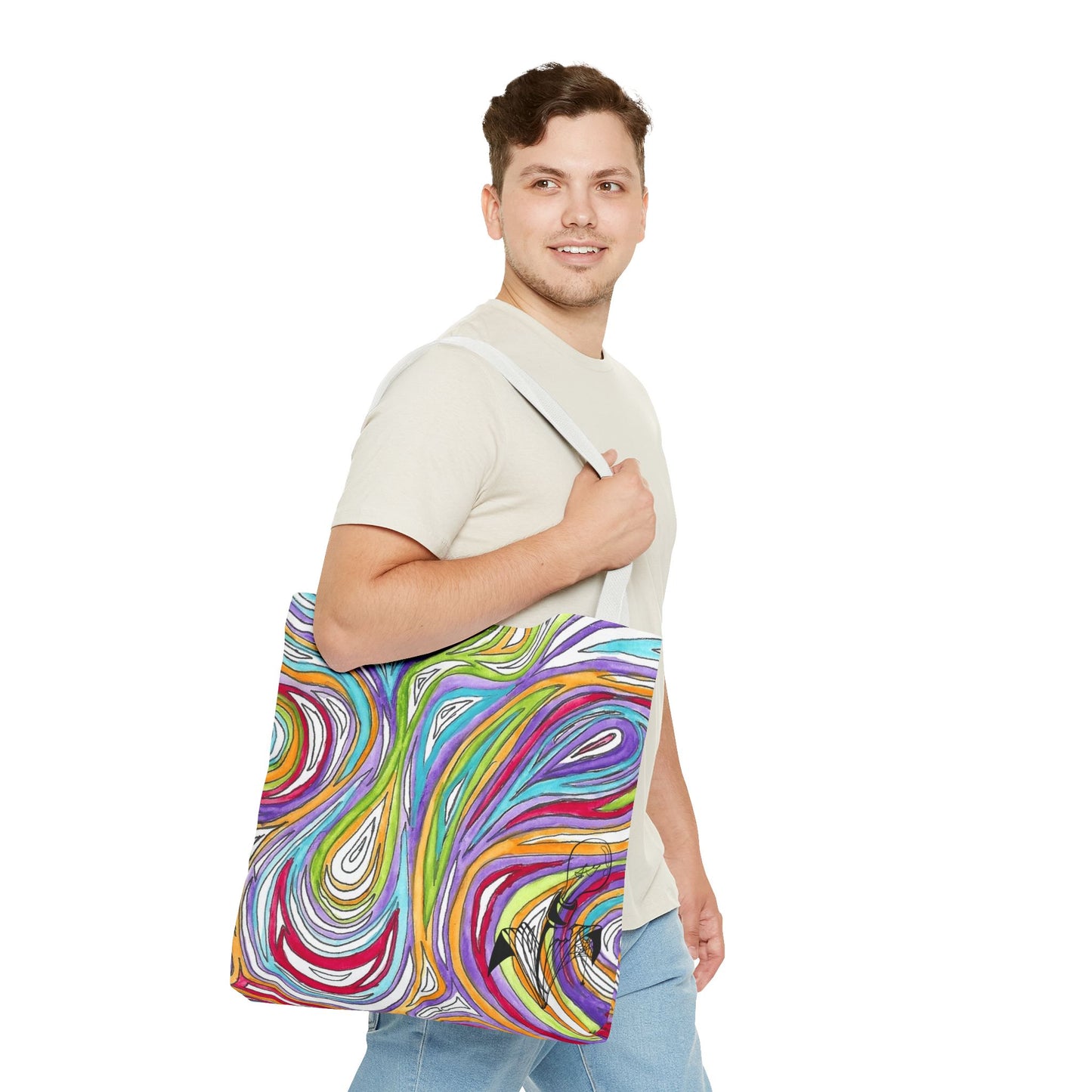 This is the White 18" x 18" Oil Spill Tote bag by Storm Garden Studios. Brunette man in white shirt, and blue jeans, side view walking to the right carrying the bag with color matched straps, abstract colors and line work, all over print. The colors are lime green, orange, light blue, dark red, purple, white and black. Storm Garden Studio logo printed in black on bottom right of tote bag. He is against a white background.