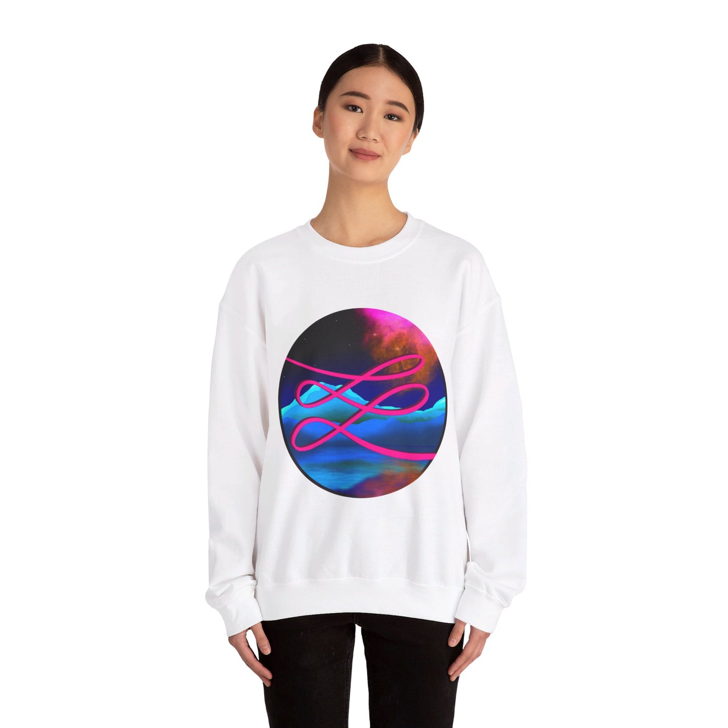 This is the White Swirl Heavy Blend Crewneck Sweatshirt by Lee Hansheng Studios. It comes in sizes S-3XL. The illustration is circular and covers the front of the shirt. The design is a hot pink swirl from left to right. The background has a mountain landscape that is reflected. The colors are pink, black, orange and blue. A lady with a smile, black hair tied up and black jeans is standing wearing the sweatshirt with her hands to the sides. She is against a white background.