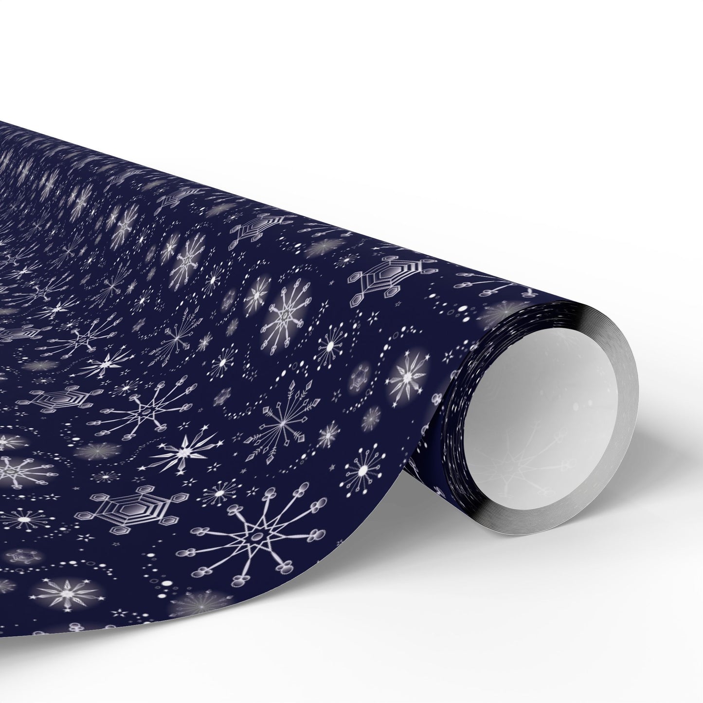 This is the matte 30" x 180" Winter Blizzard Gift Wrap. The image is a roll of wrapping paper and the design at an angle. The background is white. The design are different types of snowflakes with different sizes of circles within each flake. The wrapping paper is dark blue and the snowflakes and design are all white.