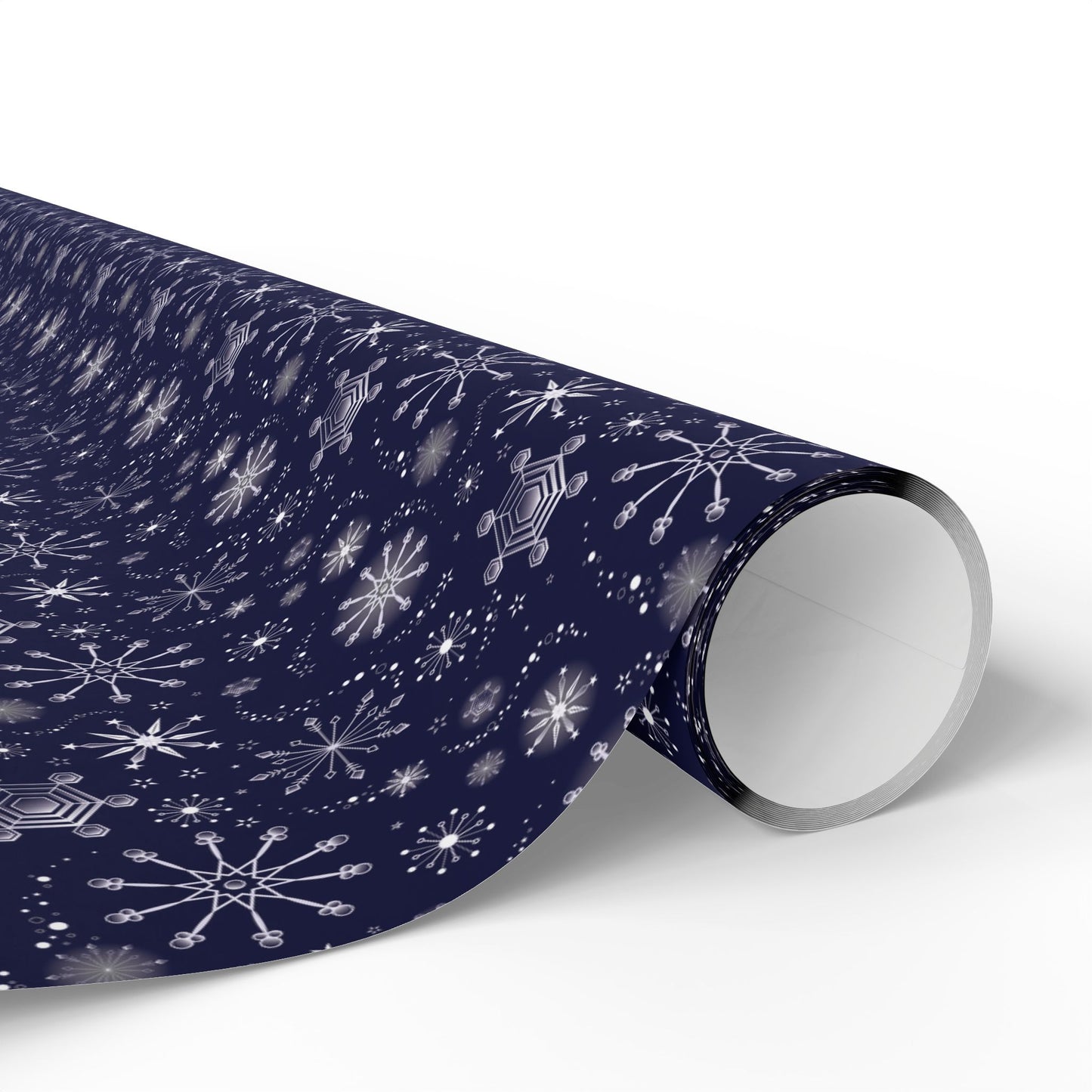 This is the matte 30" x 36" Winter Blizzard Gift Wrap. The image is a roll of wrapping paper and the design at an angle. The background is white. The design are different types of snowflakes with different sizes of circles within each flake. The wrapping paper is dark blue and the snowflakes and design are all white.