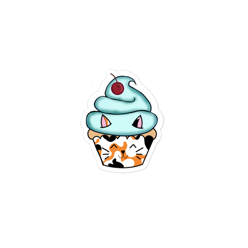 The Art Collective International Cat Cupcake sticker featuring a pastel pink cupcake with a black dazzle and dagger design