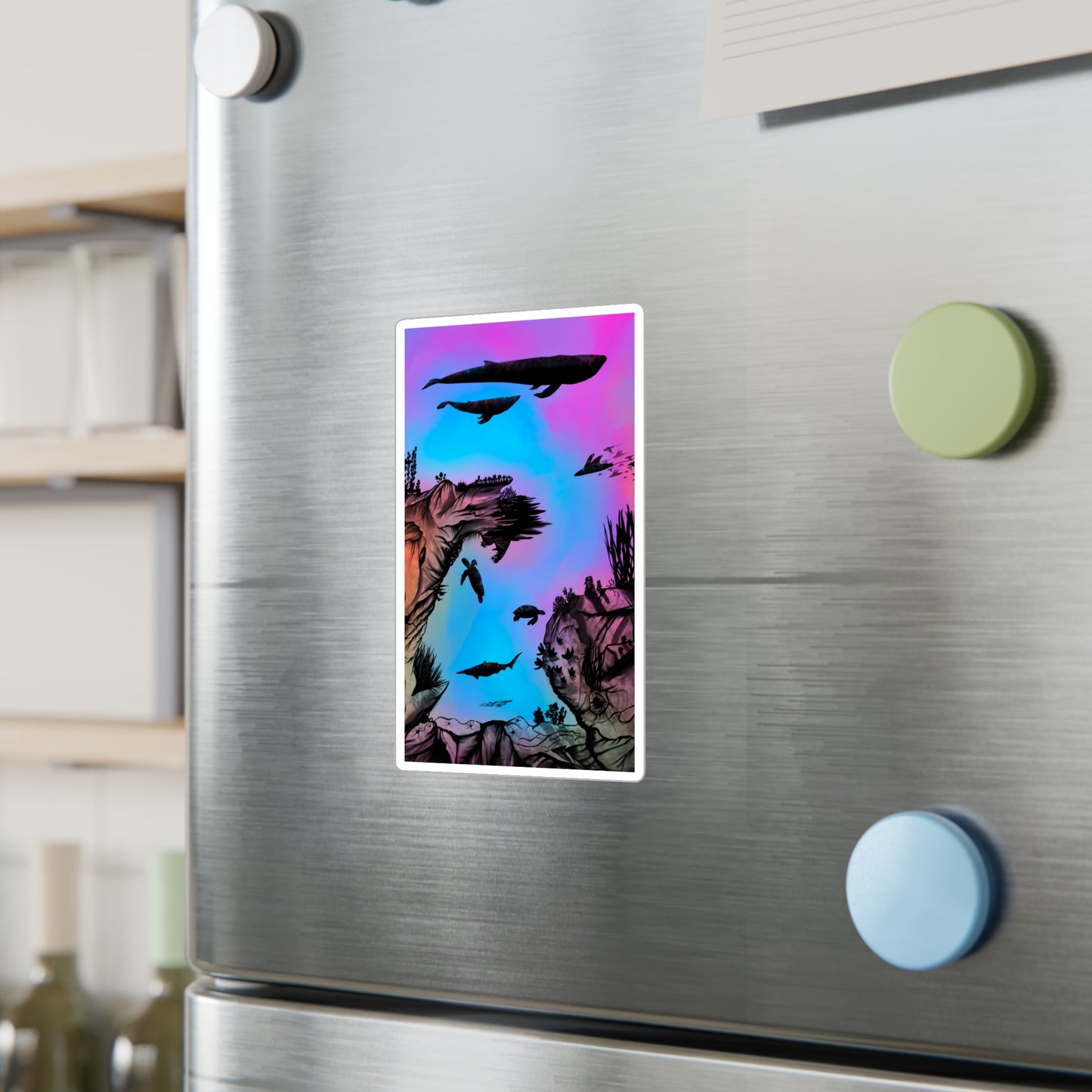 A 4" x 6" kiss-cut vinyl decal underwater seascape with aquatic plants on a marbled background. There are two blue whales, 1 goblin shark, school of eagle rays, two sea turtles and a school of fish on a stainless steel fridge with magnets on the foreground and wine bottles on the left.