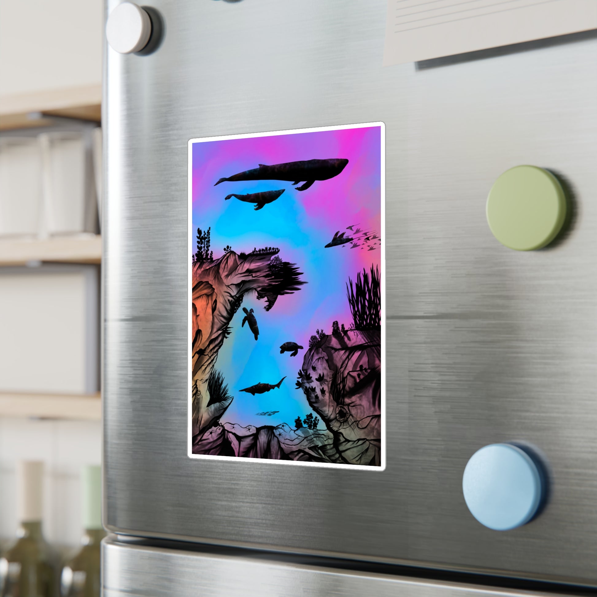 A 6" x 8" kiss-cut vinyl decal underwater seascape with aquatic plants on a marbled background. There are two blue whales, 1 goblin shark, school of eagle rays, two sea turtles and a school of fish on a stainless steel fridge with three magnets in the foreground. shelf and wine bottles in the background.