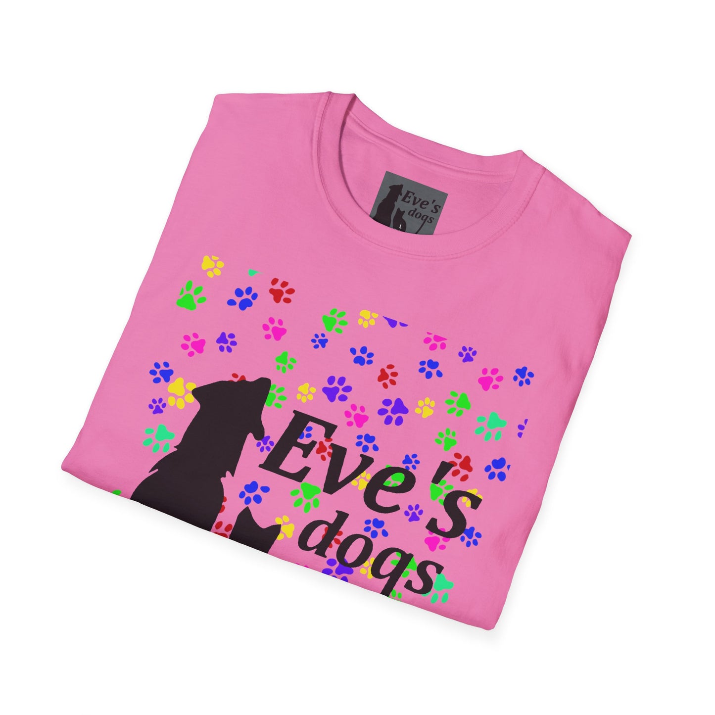 This is the Azalea Adopt Eve's Dogs T-Shirt. It comes in XS - 5XL. The image is the shirt folded and showing the front. The size label is a grey and black tag with a dog and cat with the "Eve's dogs" writing. The front has pink, green, blue, purple, red paw prints in different sizes. Also, the dog and cat with "Eve's dogs" printed in black. It is against a white background.