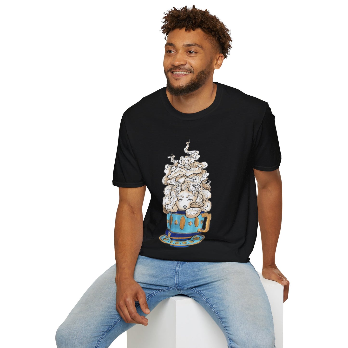 This is the Black Earl Grey Softstyle T-Shirt by Chris Foster Design. It comes in sizes XS-5XL. The illustration is of a gold, light blue and dark blue teacup with a tan, yellow and white steam. The steam is swirly and goes up and outwards. In the middle is a lady's face. A smiling man sitting on a white podium with one hand on the back edge, light jeans, looking to the left and wearing the t-shirt. 