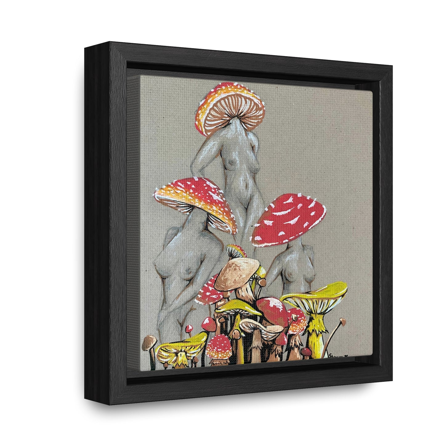 This is the 6" x 6" Miss Amanita Gallery Canvas Wrap with Black Square Frame by Storm Garden Studio. The depth of the frame is 1.25".The image shows the canvas tilted towards the left on a white wall. This is an illustration of three mushroom headed nude women. The foreground has assorted mushrooms in different sizes. The women are positioned in a triangle shape. The colors range from yellow,orange and red.Each of the bodies are shaded in white,black or grey and match the background of the illustration. 