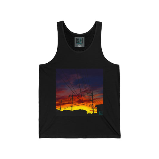 This is the Black Saitama Sunset Tank by Lee Hansheng Studios. It showcases the front of the tank. The illustration is a landscape view towards the sky. There are building, power lines, sky lines all black. The sunset is colors of yellow, orange and red. The sky and clouds are grey, white and dark blue colors mixed together. There is the studio logo on the right corner, printed in black outlined in blue and inside of shirt with same logo on gray label, sizes and ingredients printed in white.