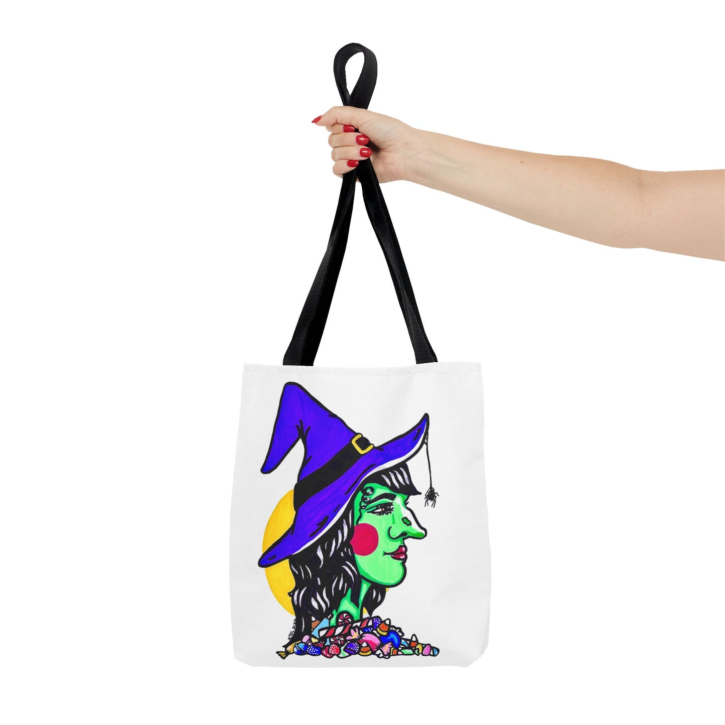 This is the Black 13" x 13" Witch Tote Bag by Storm Garden Studio.The handles are color matched.It shows the side profile image of a witch.She is facing the left side.She has a purple witch hat with a black belt, yellow buckle, a spider crawling down the front, red rosy cheeks, red lips and assorted candy under the neck.Behind her is a bright yellow circle past her hair.A woman's hand with red nail polish is grabbing the handles. Her arm is outstretched to the middle. The tote is against a white background.