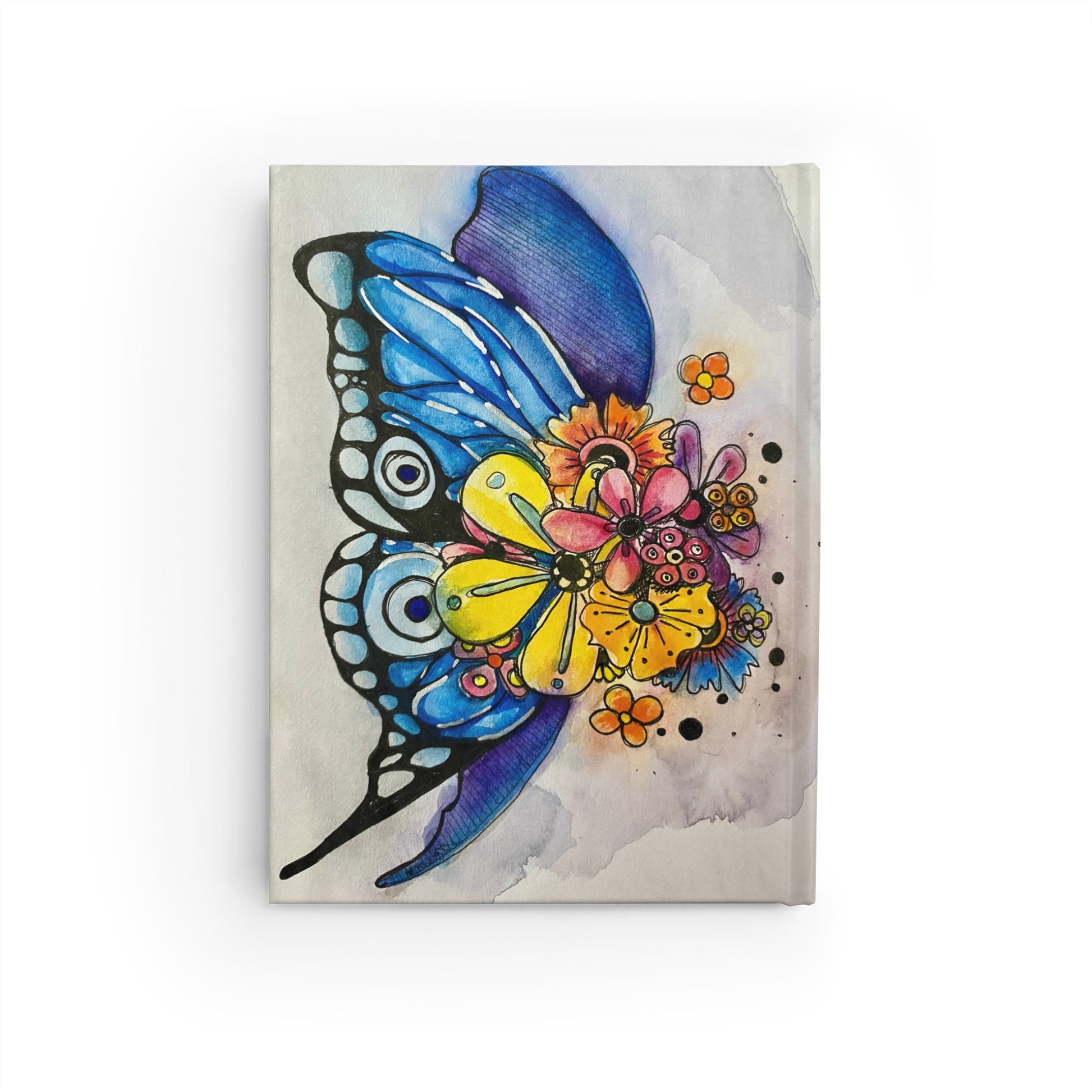 This is the Blooming Sketchbook Journal by Storm Garden Studio. This shows the back. There is another illustration of a water colored blue butterfly with bursting flowers covering it's body. There are various flowers with colors of orange, yellow, red, purple and blue. The back wing is mixed between blue and purple.  The background is a mized between purple and red spread around lightly. The base color of the journal is more tan/beige. The journal is against a white background.