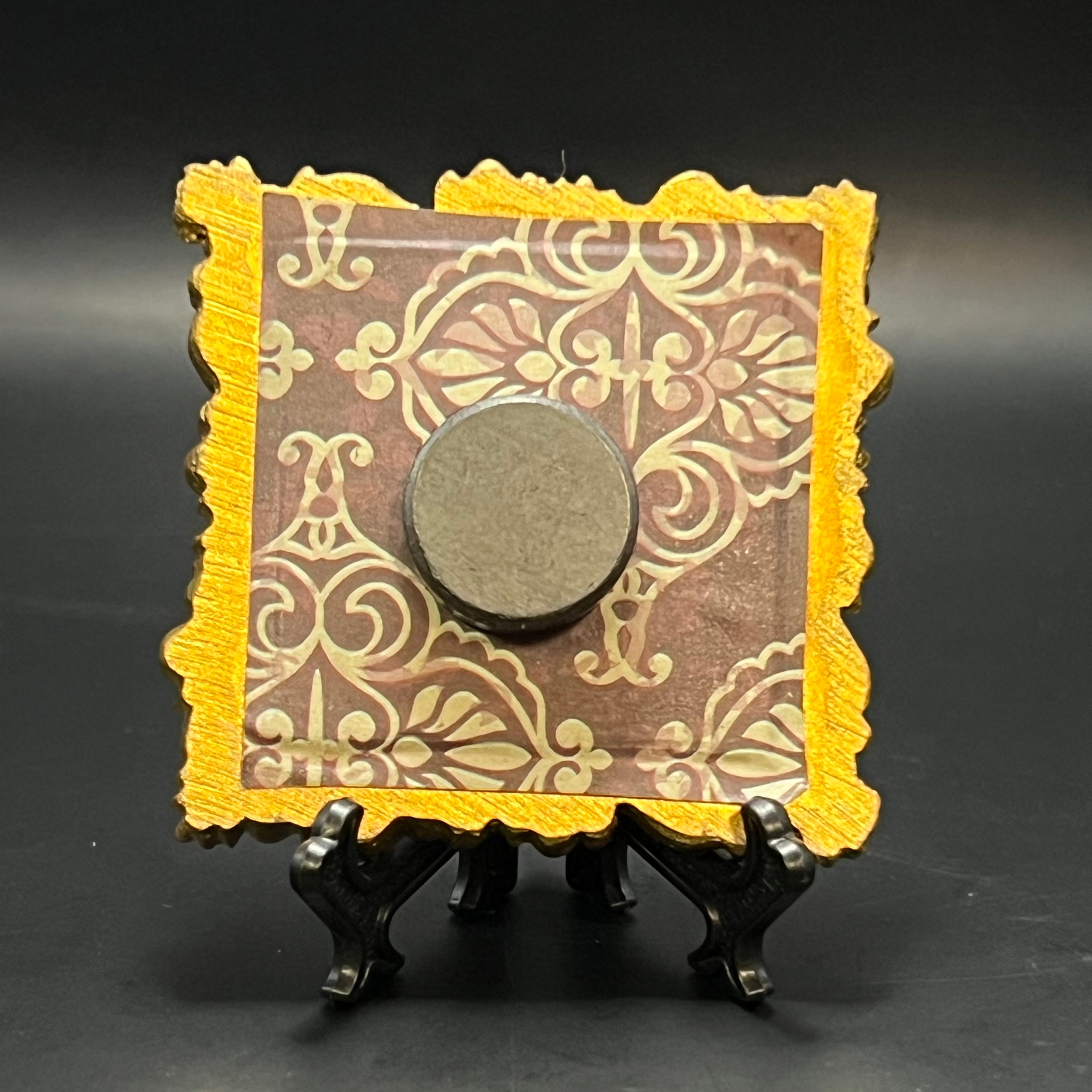 Close-up of the miniature painting’s textured surface highlighting vibrant blue and subtle brushstroke details against a