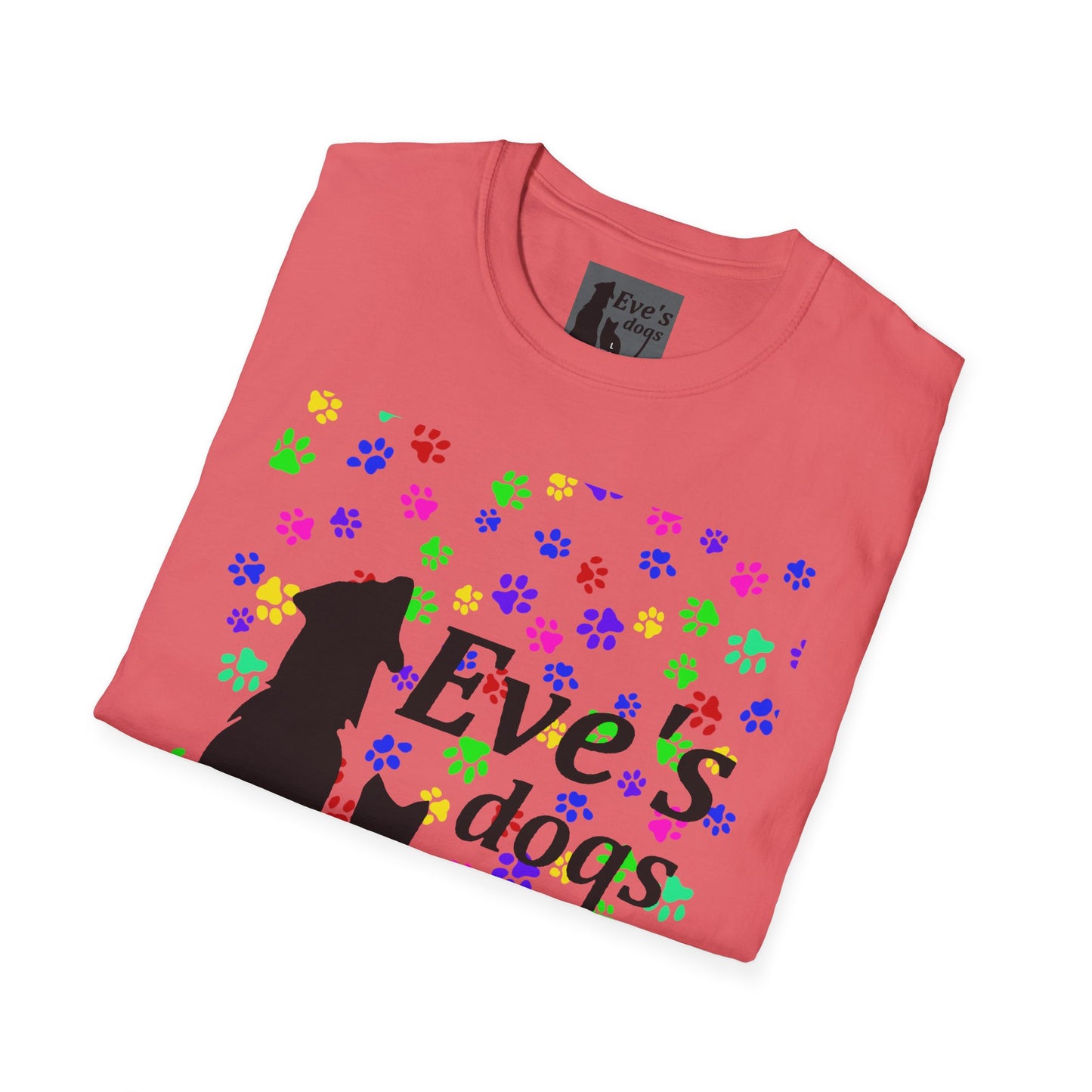 This is the Coral Silk Adopt Eve's Dogs T-Shirt. It comes in XS - 5XL. The image is the shirt folded and showing the front. The size label is a grey and black tag with a dog and cat with the "Eve's dogs" writing. The front has pink, green, blue, purple, red paw prints in different sizes. Also, the dog and cat with "Eve's dogs" printed in black. It is against a white background.