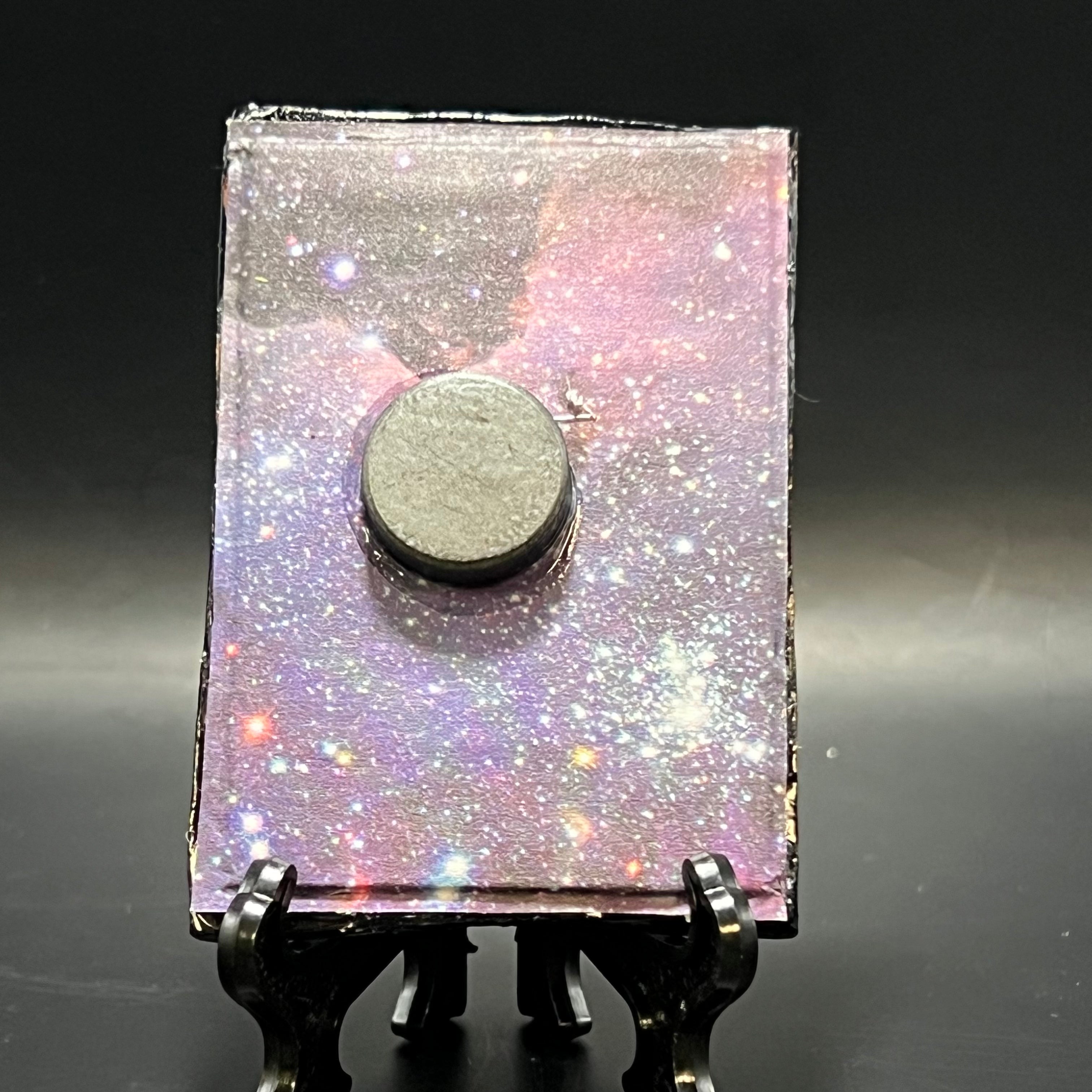 Close-up of textured brushstrokes highlighting vibrant starburst details on the Crescent Nebula mini painting, framed and