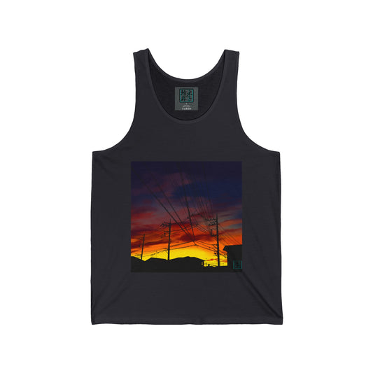 This is the Dark Grey Saitama Sunset Tank by Lee Hansheng Studios. It showcases the front of the tank. The illustration is a landscape view towards the sky. There are building, power lines, sky lines all black. The sunset is colors of yellow, orange and red. The sky and clouds are grey, white and dark blue colors mixed together. There is the studio logo on the right corner, printed in black outlined in blue and inside of shirt with same logo on gray label, sizes and ingredients printed in white.